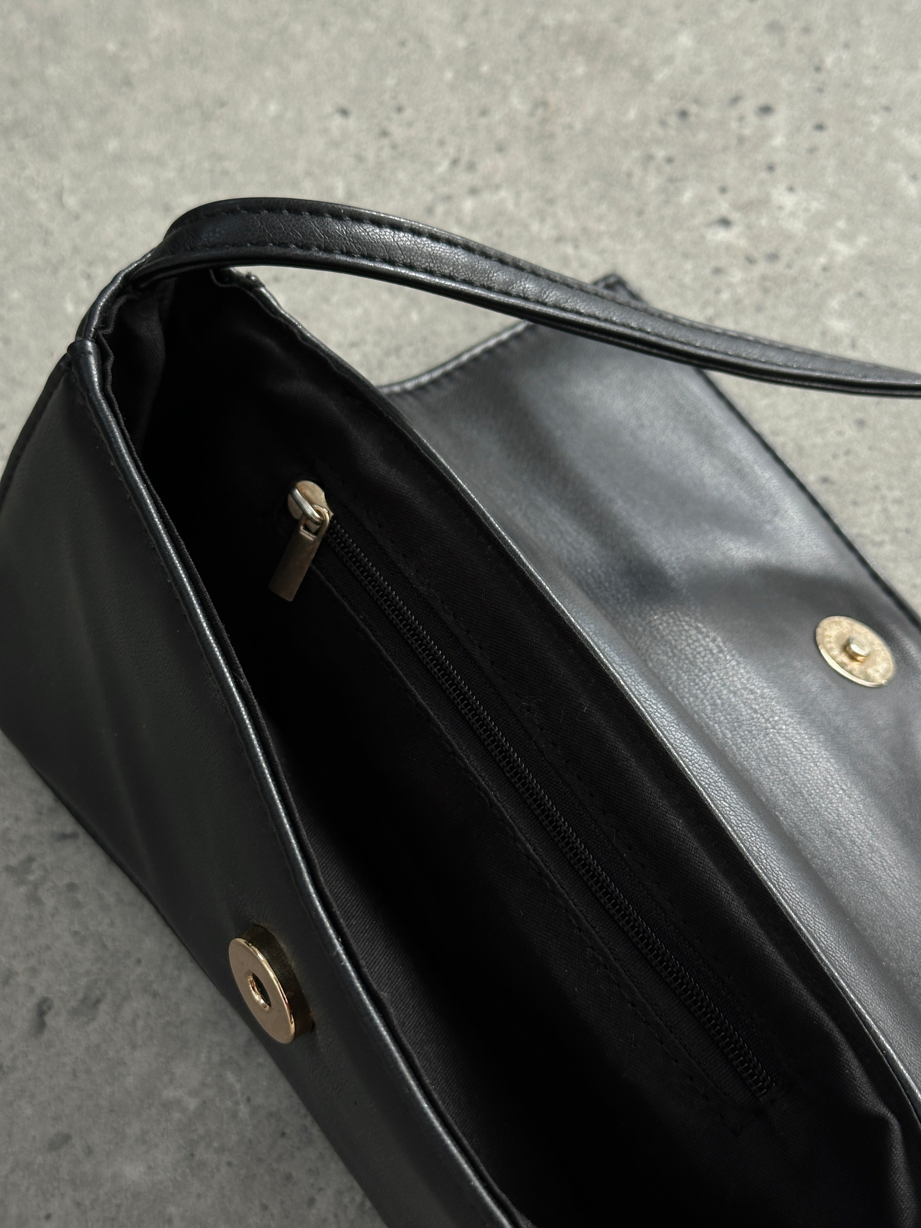 Vintage faux leather curved shoulder bag with adjustable strap and classic design, perfect for everyday use.
