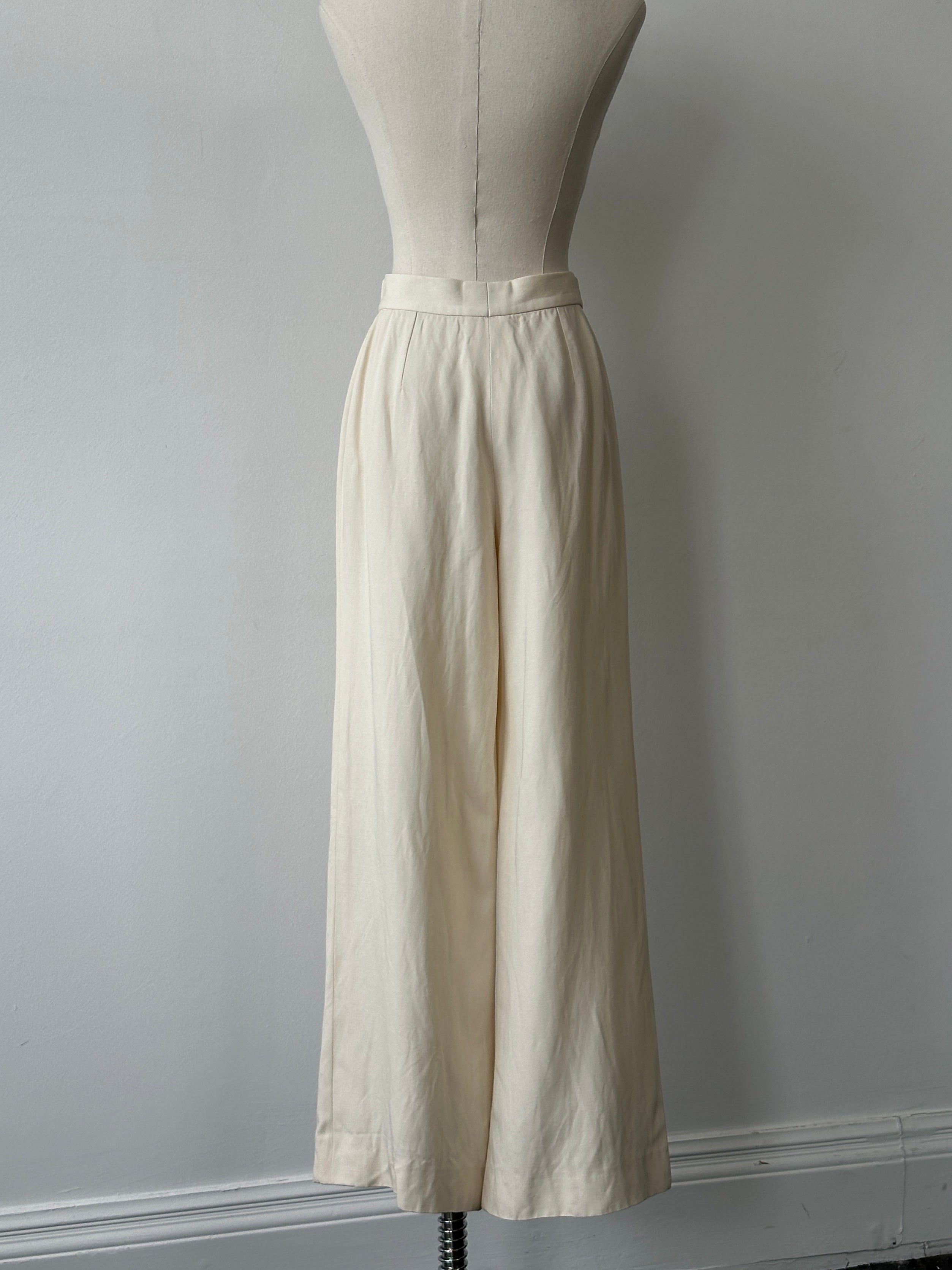 Giorgio Armani 1990s wide-leg tailored trousers in beige, showing the high waist and classic cut with belt loops.