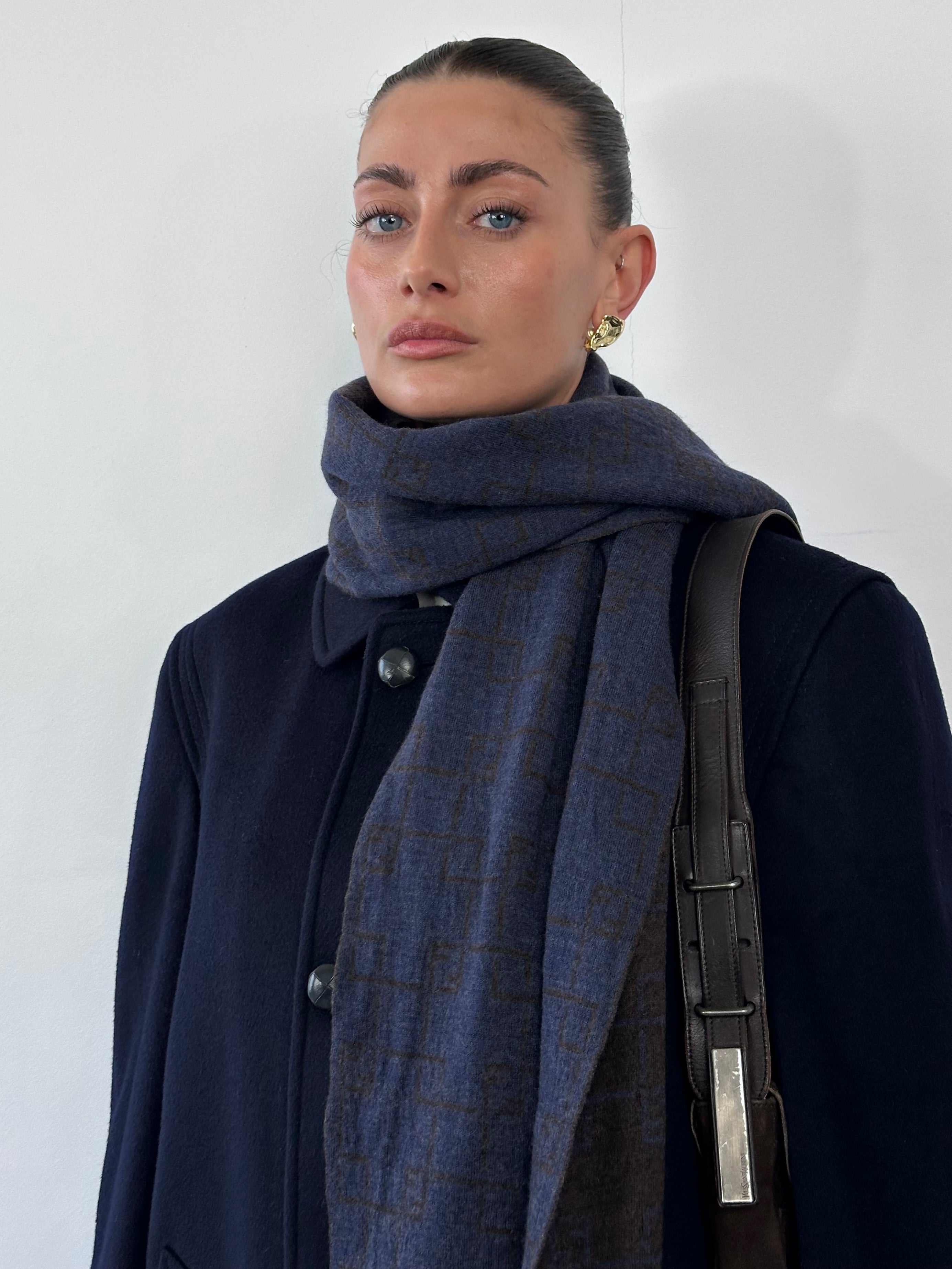 Fendi wool check scarf featuring a classic pattern with fringed edges, stylish and warm accessory for cold weather.