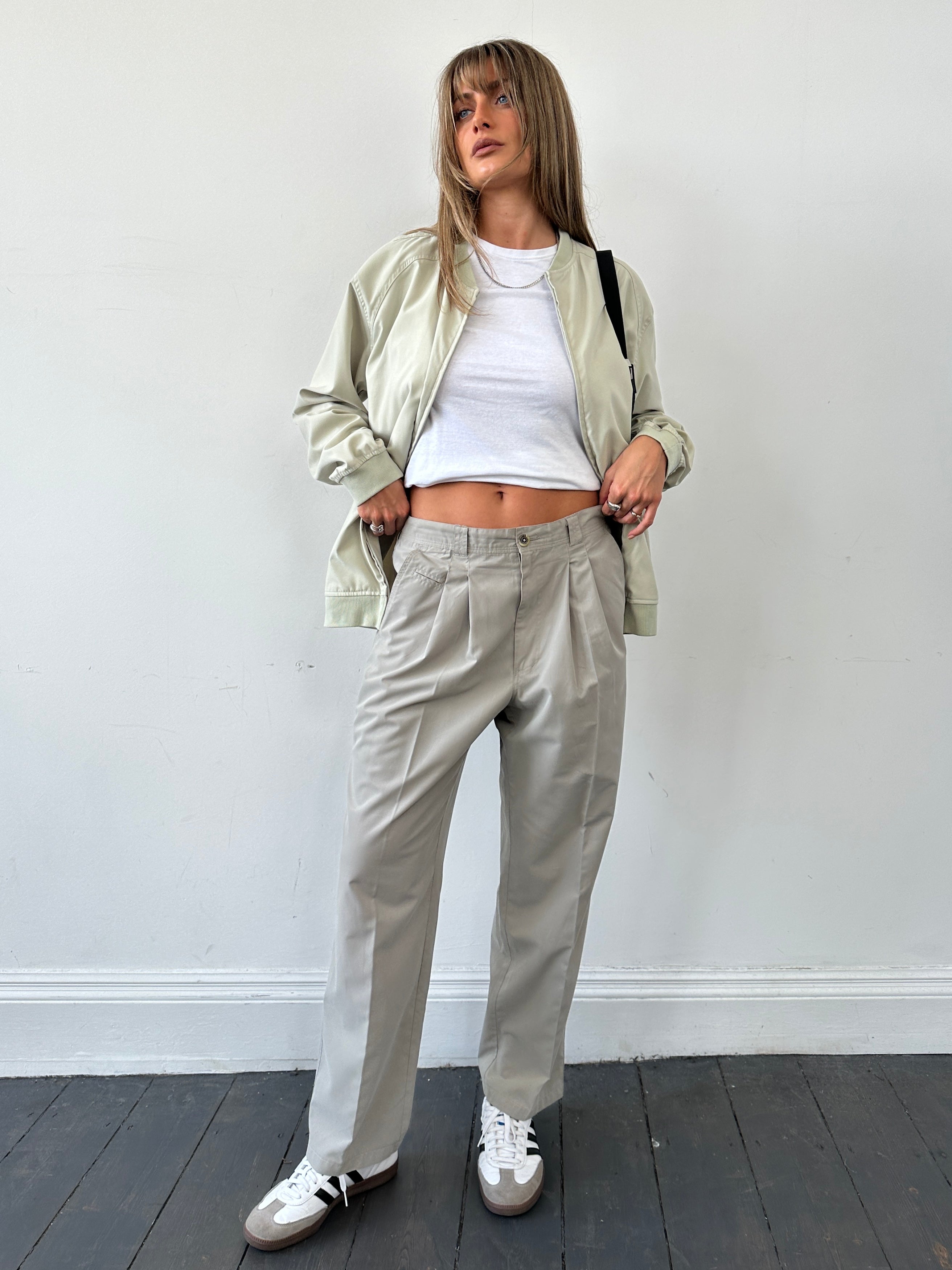 Vintage brand vintage straight leg pleated relaxed trousers in waist size 32, shown in a neutral fabric with a classic fit.