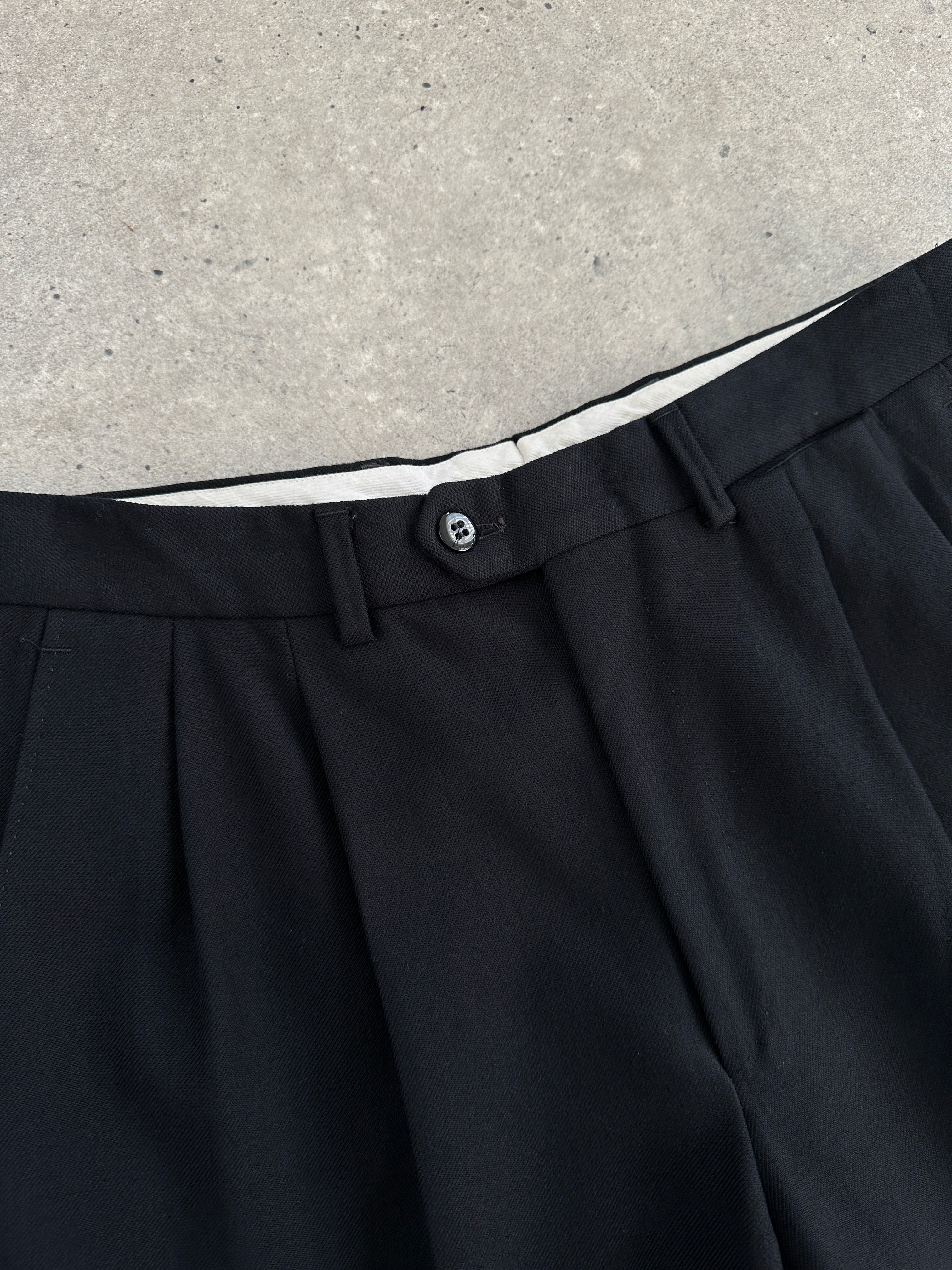 Vintage pure wool tapered leg tailored trousers in W28, showcasing a classic fit with a smooth fabric finish.