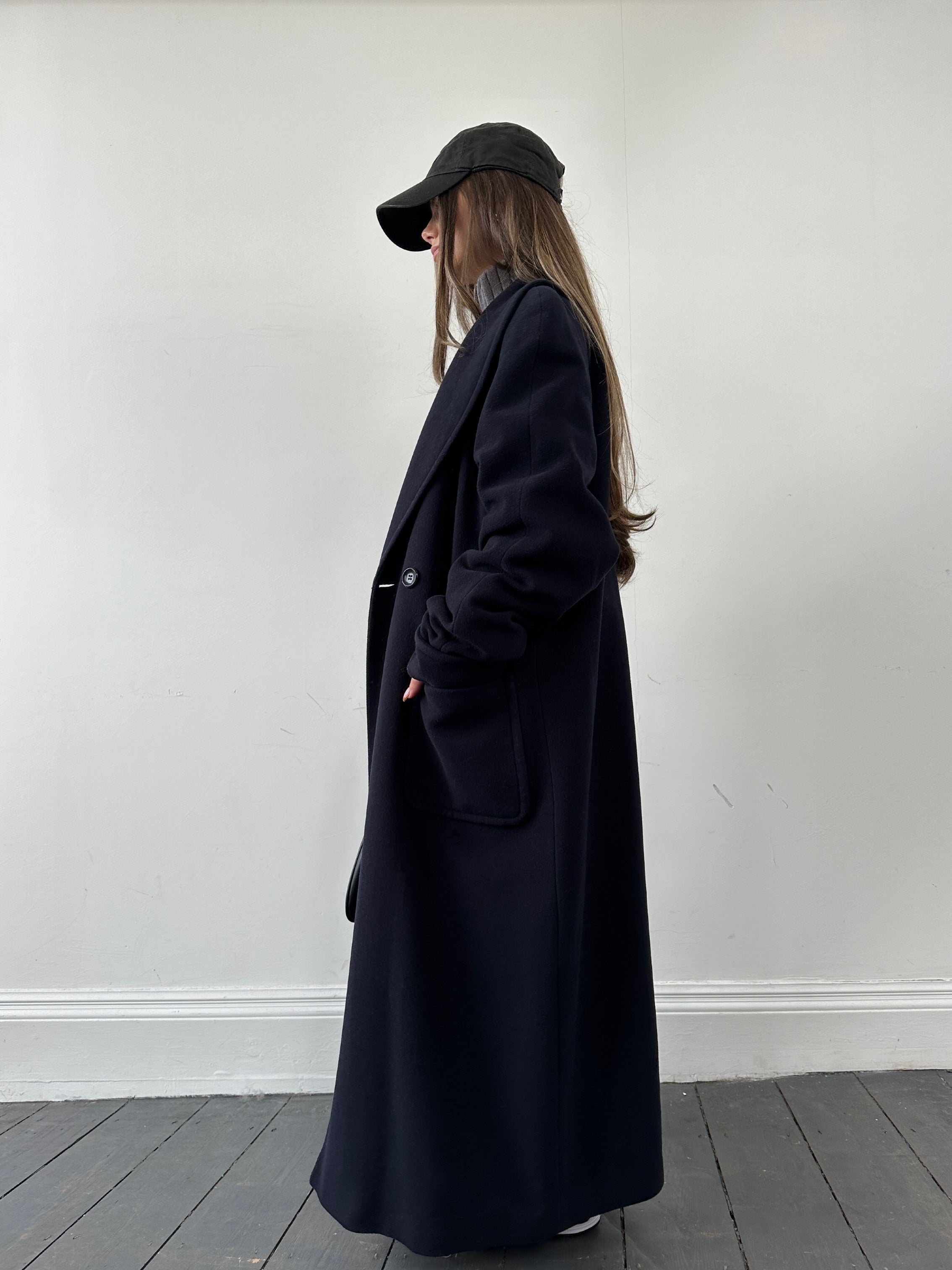 Vintage wool double-breasted coat in size M, featuring classic design and button details, displayed on a hanger.