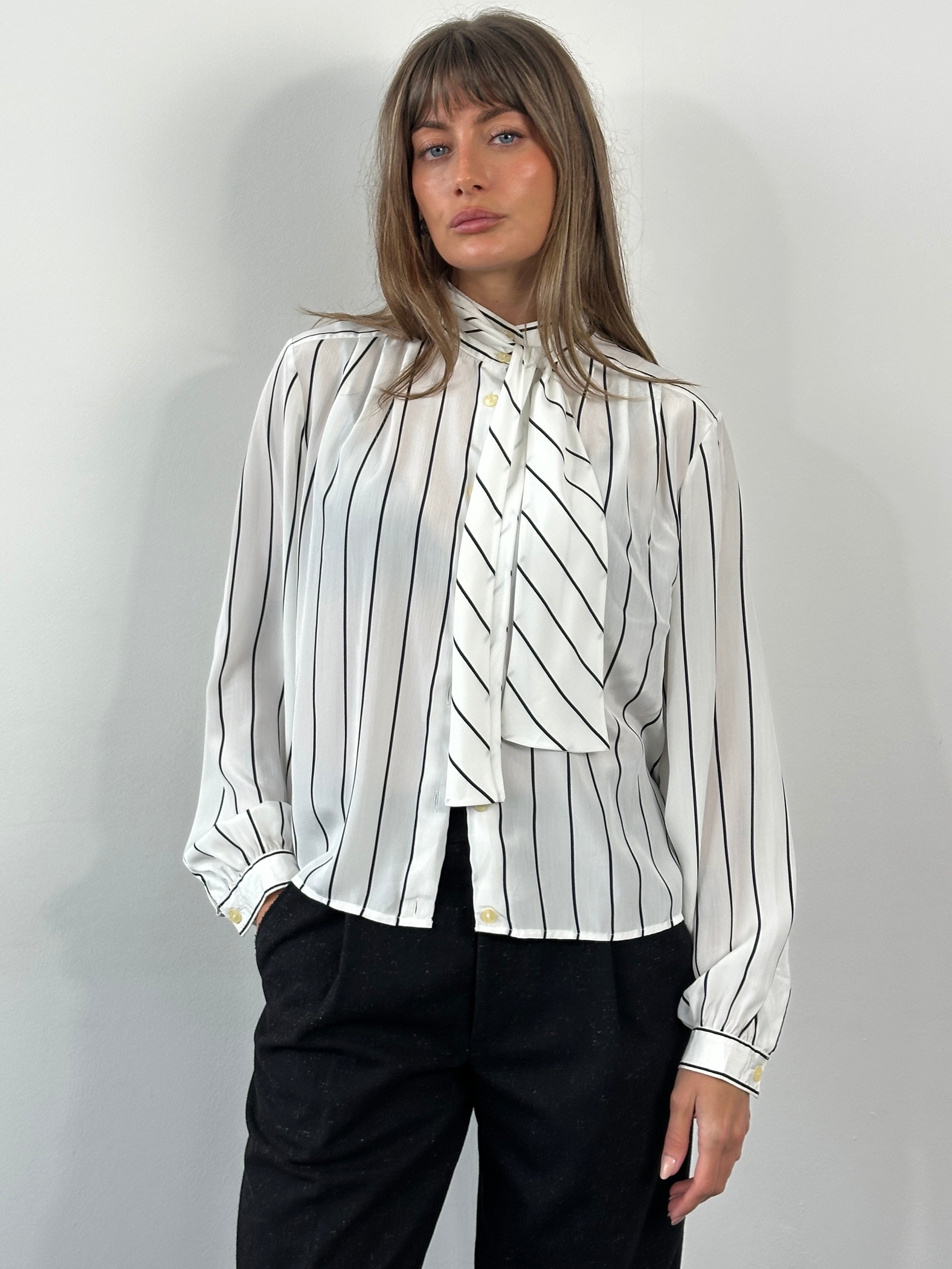 Vintage 1980s sheer stripe tie-neck shirt in size M, featuring lightweight fabric and classic vintage design, displayed on a hanger.