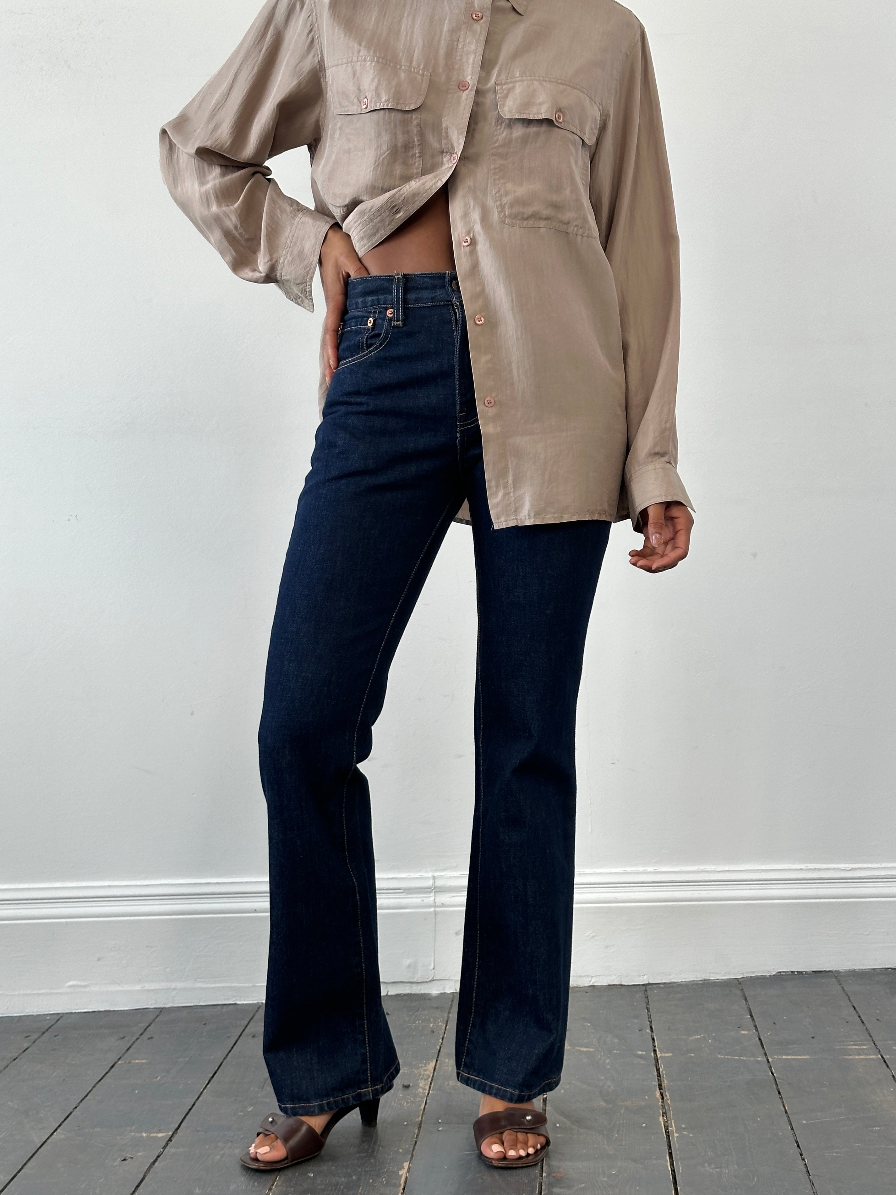 Levi’s 525 mid-rise denim bootcut jeans in W26, showing classic blue wash, fitted waist, and flared leg style.