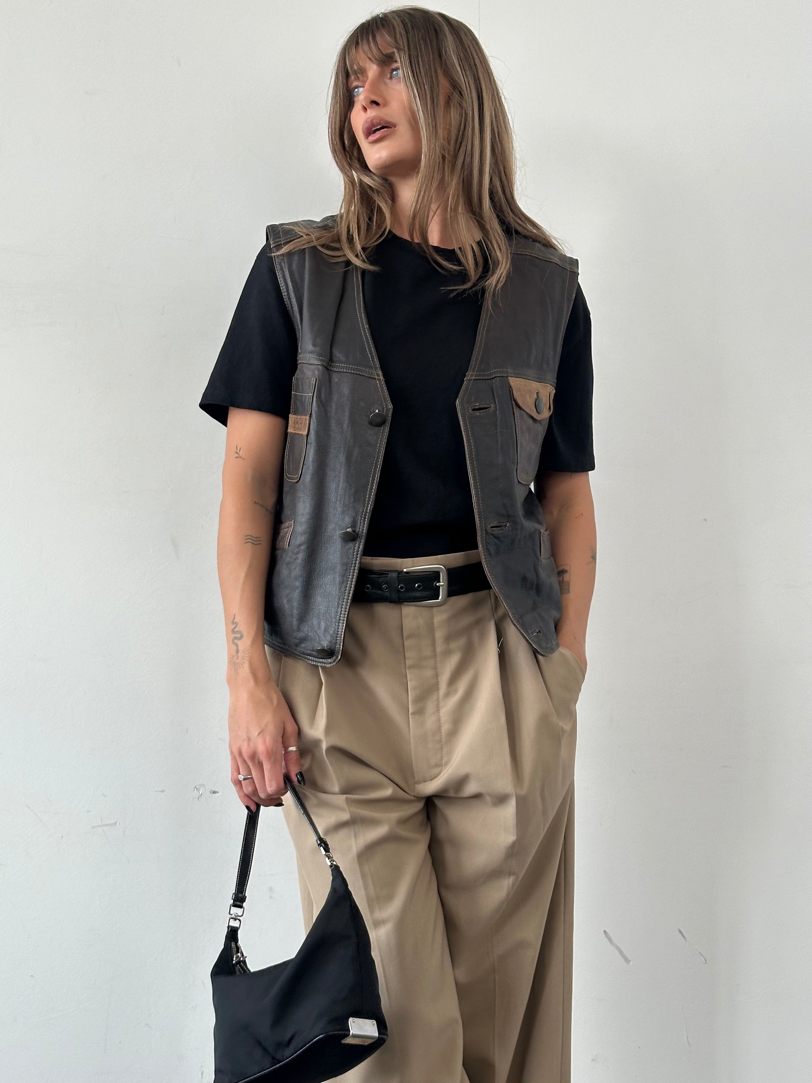 Vintage camel distressed leather waistcoat, men's medium-sized stylish sleeveless vest with rugged texture and classic design.