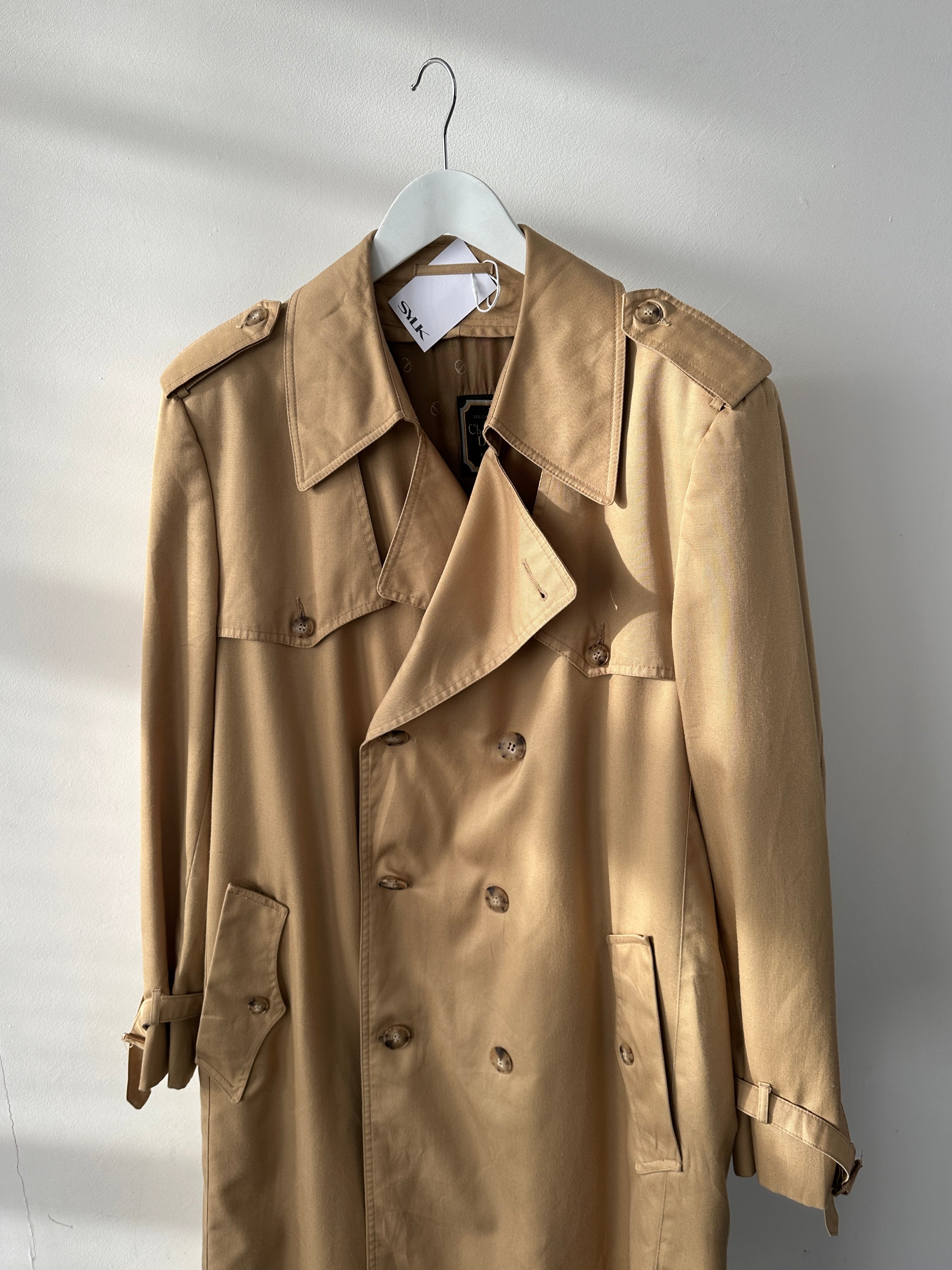 Christian Dior cotton double-breasted trench coat in size L/XL, showing the classic tailored design with belt and button details.
