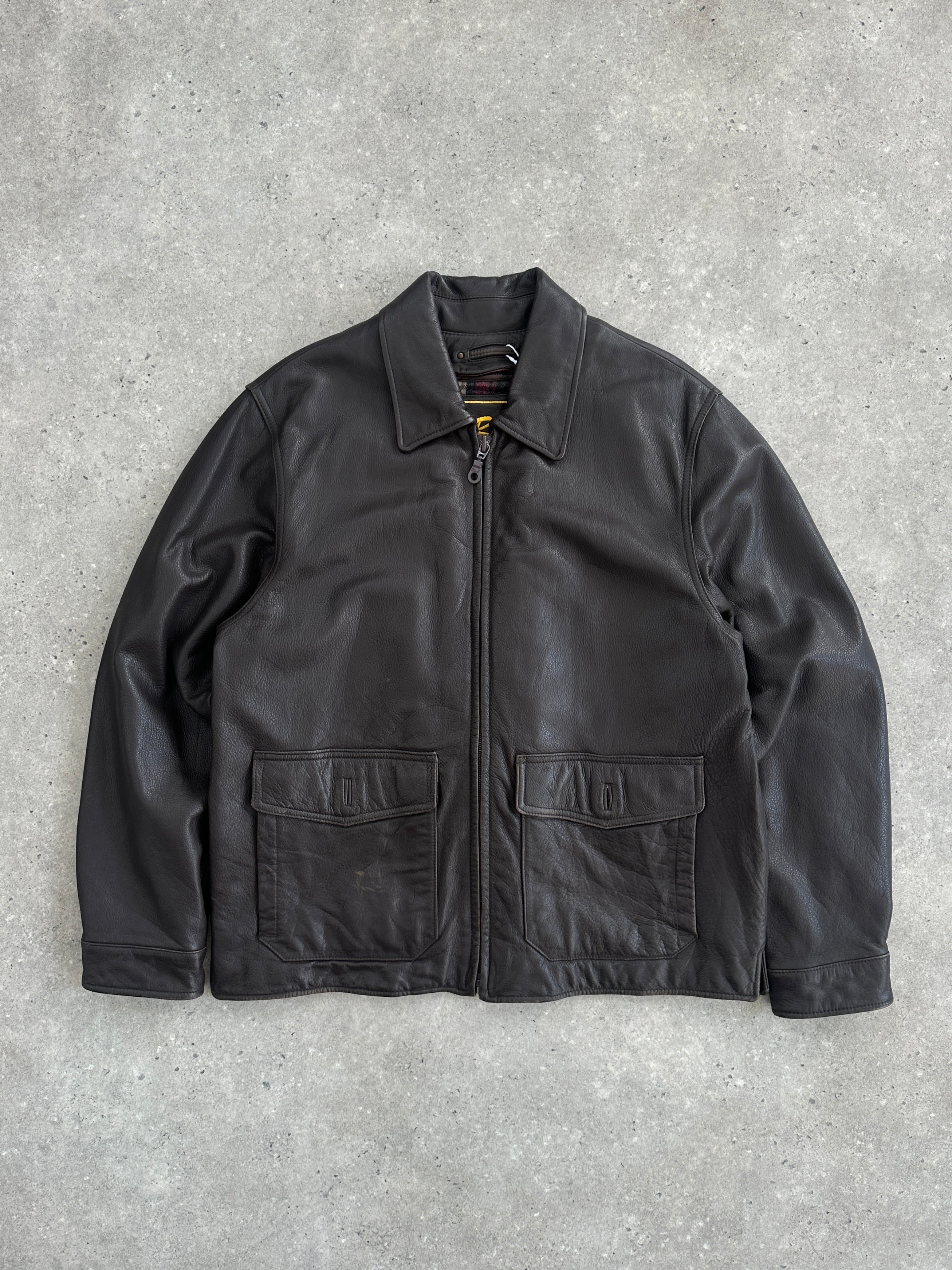 Vintage boxy leather jacket in size large, featuring classic design and durable leather material, displayed on a hanger.
