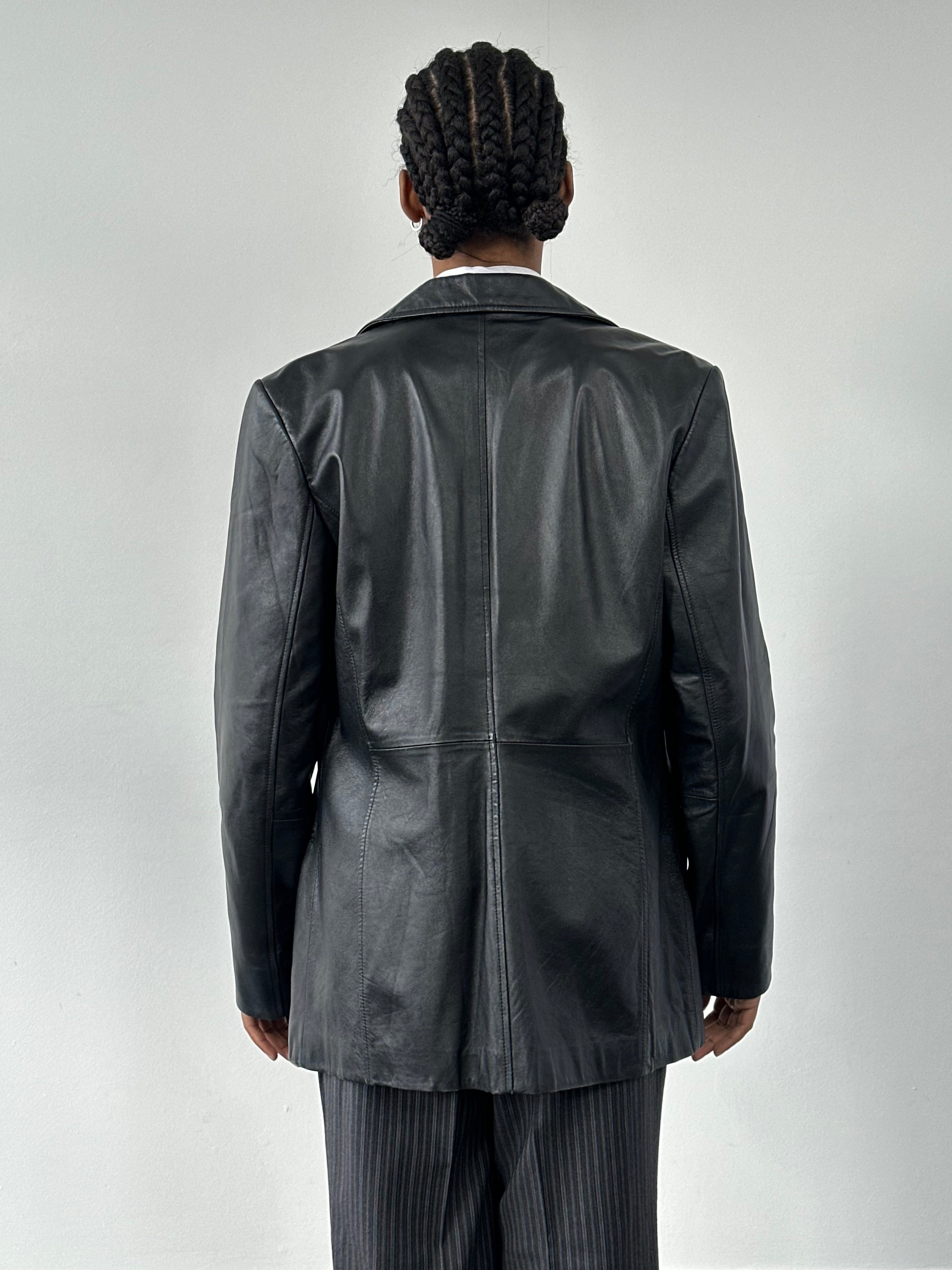 Vintage 1990s minimal leather jacket, size M, featuring sleek design and classic black leather for a timeless look.
