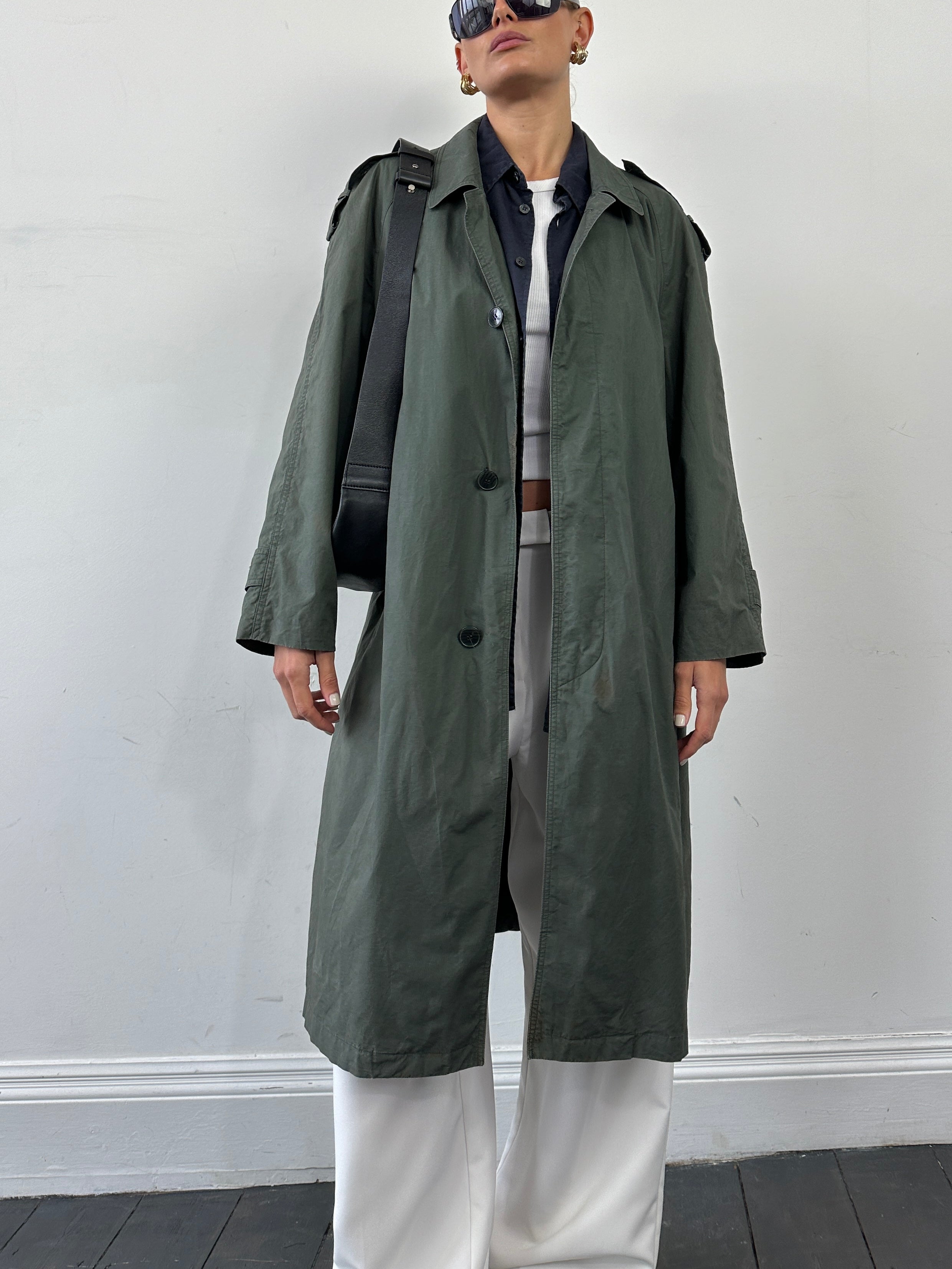 Yves Saint Laurent Diffusion Hommes pure cotton trench coat with concealed placket in size L, shown hanging on a neutral background.