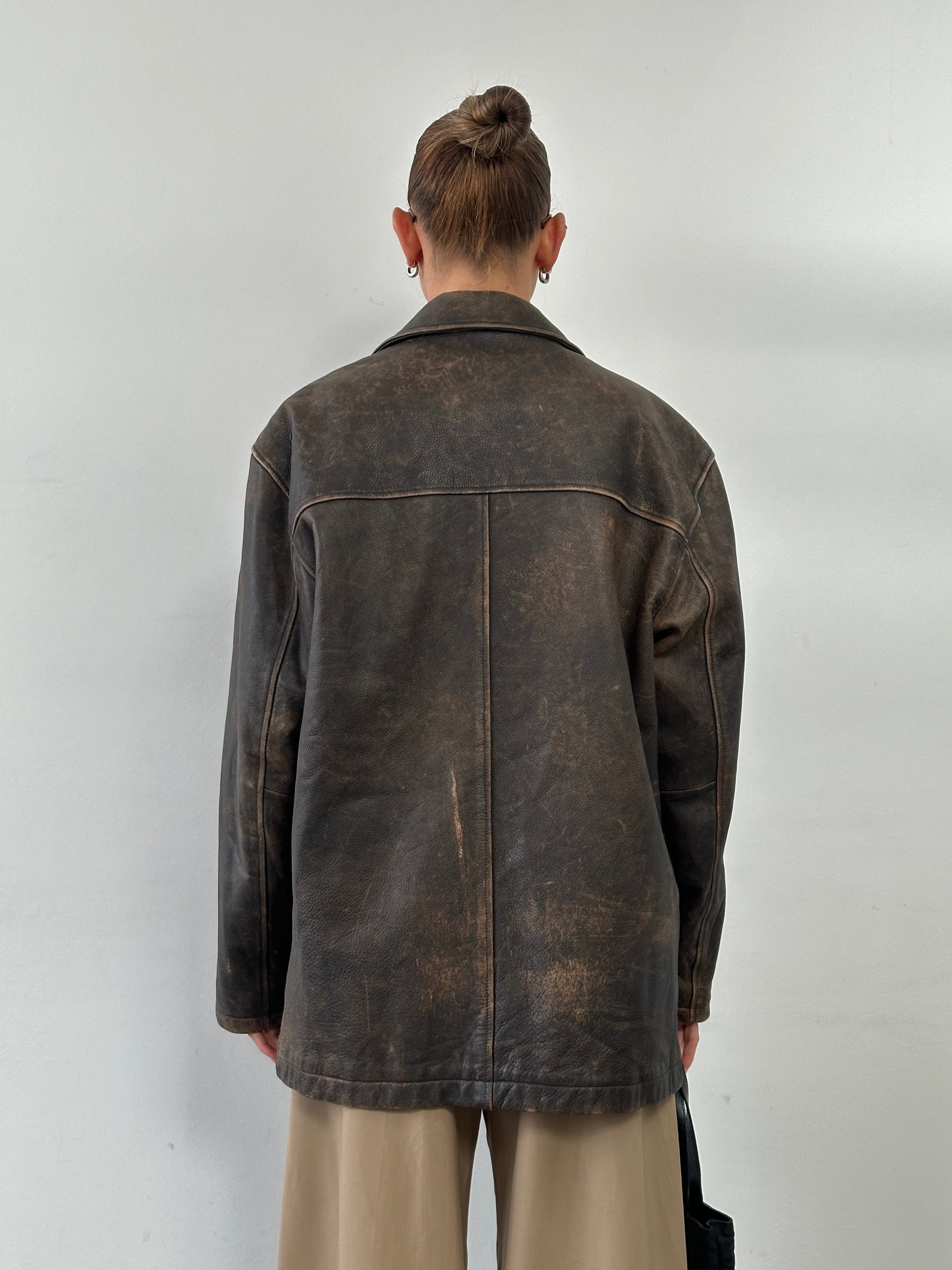 Guess distressed leather jacket in XL, featuring rugged design and classic style, displayed on a hanger.