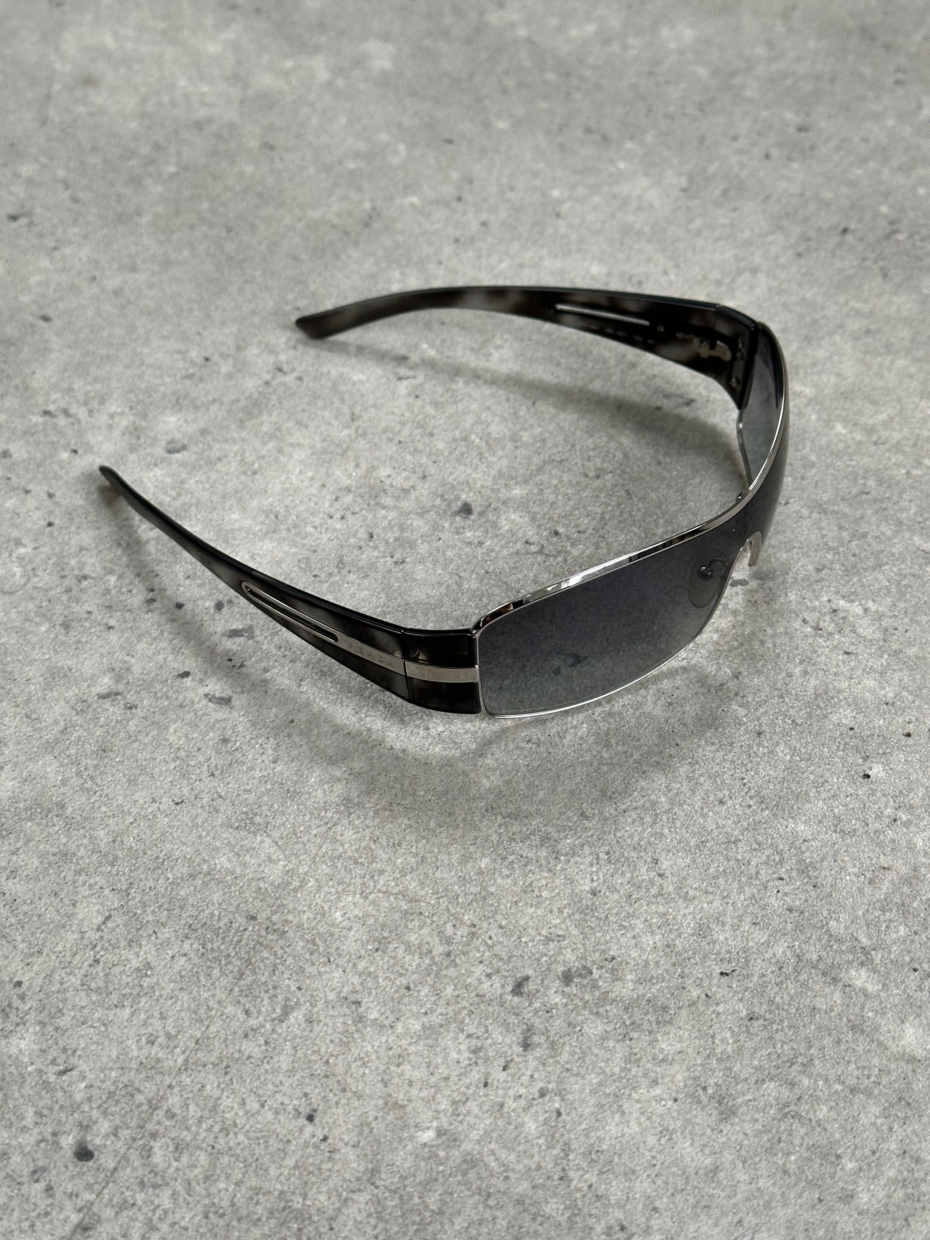 Prada 2000s aviator shield sunglasses with dark tinted lenses and metal frame, stylish and iconic eyewear design.