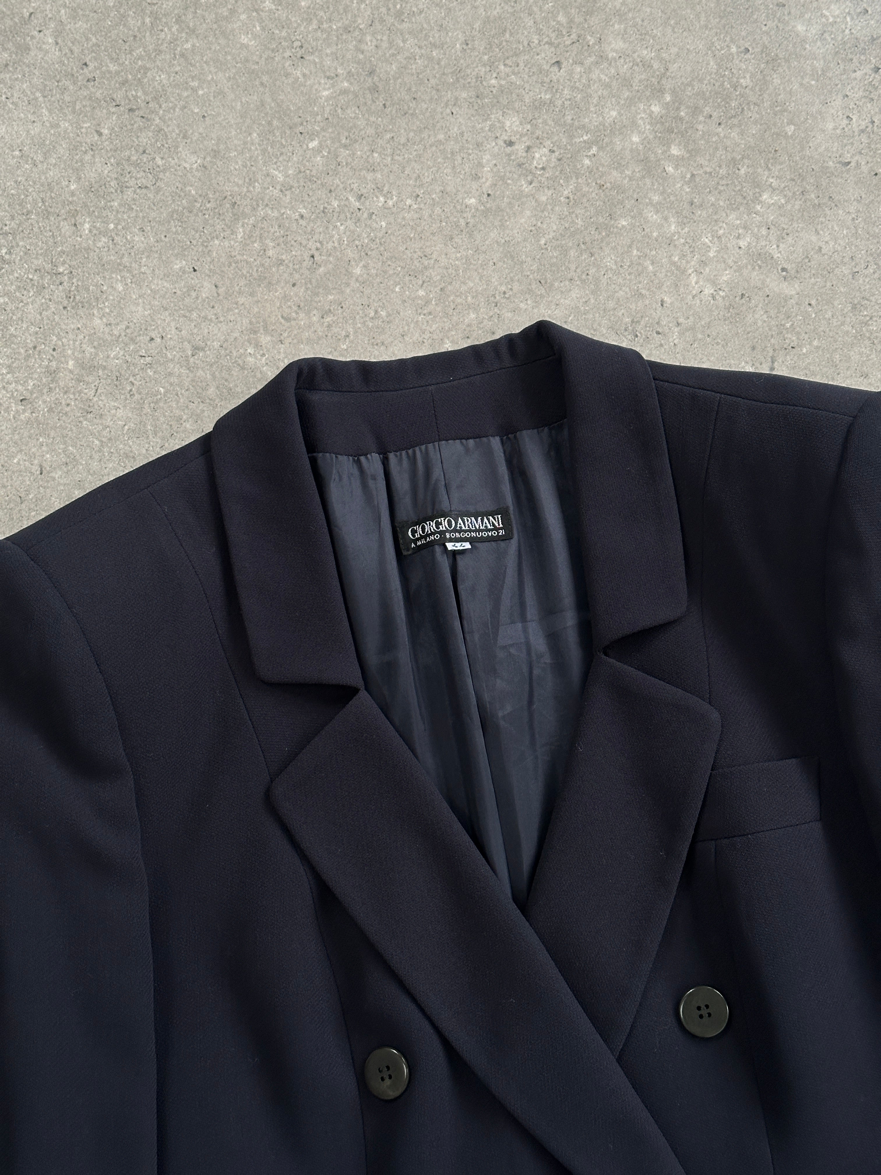 Giorgio Armani Black Label pure wool fitted blazer in black, shown on a mannequin, with a tailored lapel and sleek design.