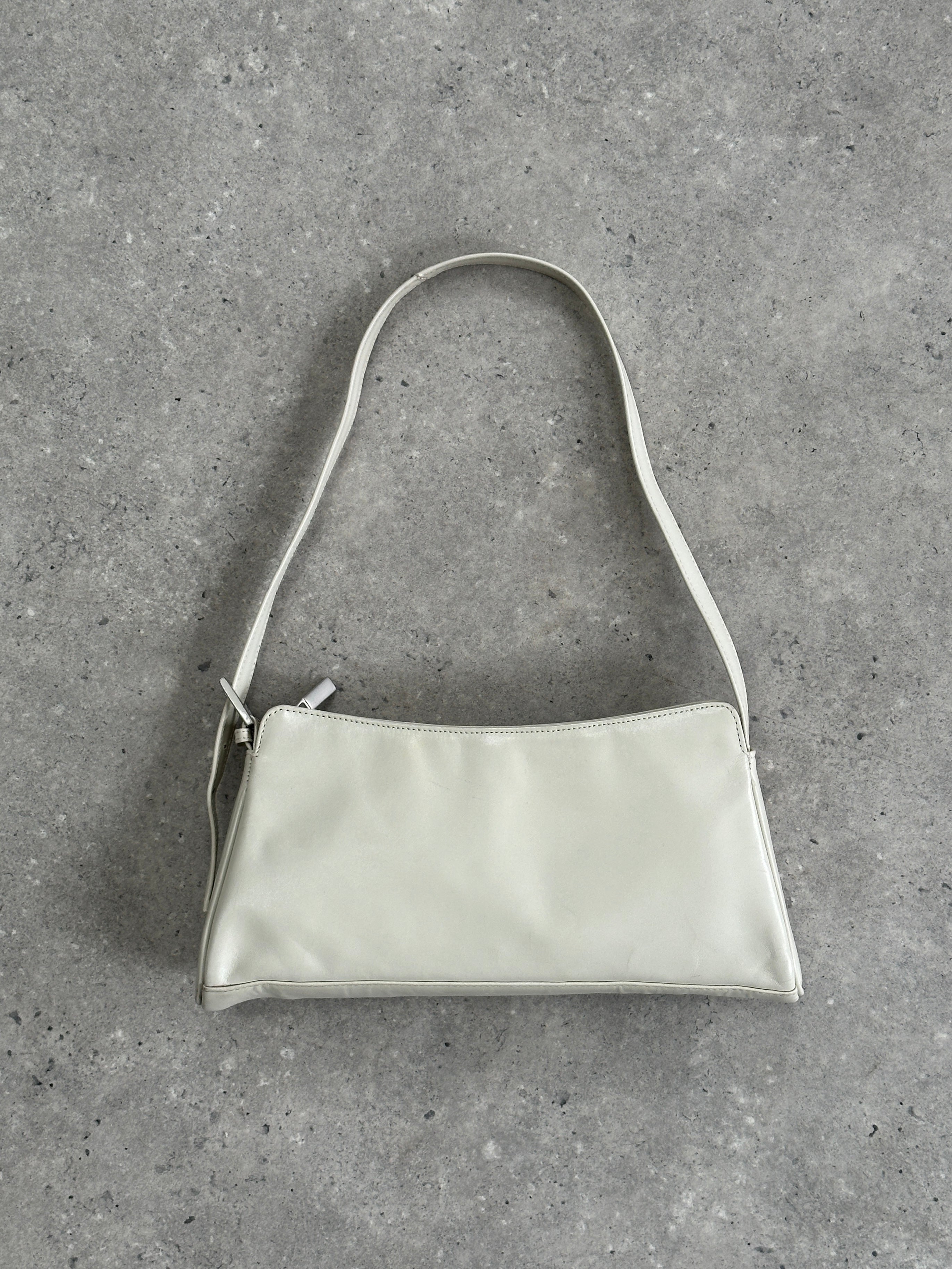 Vintage faux leather A-line shoulder bag with a structured design and top handle, featuring classic vintage style details.