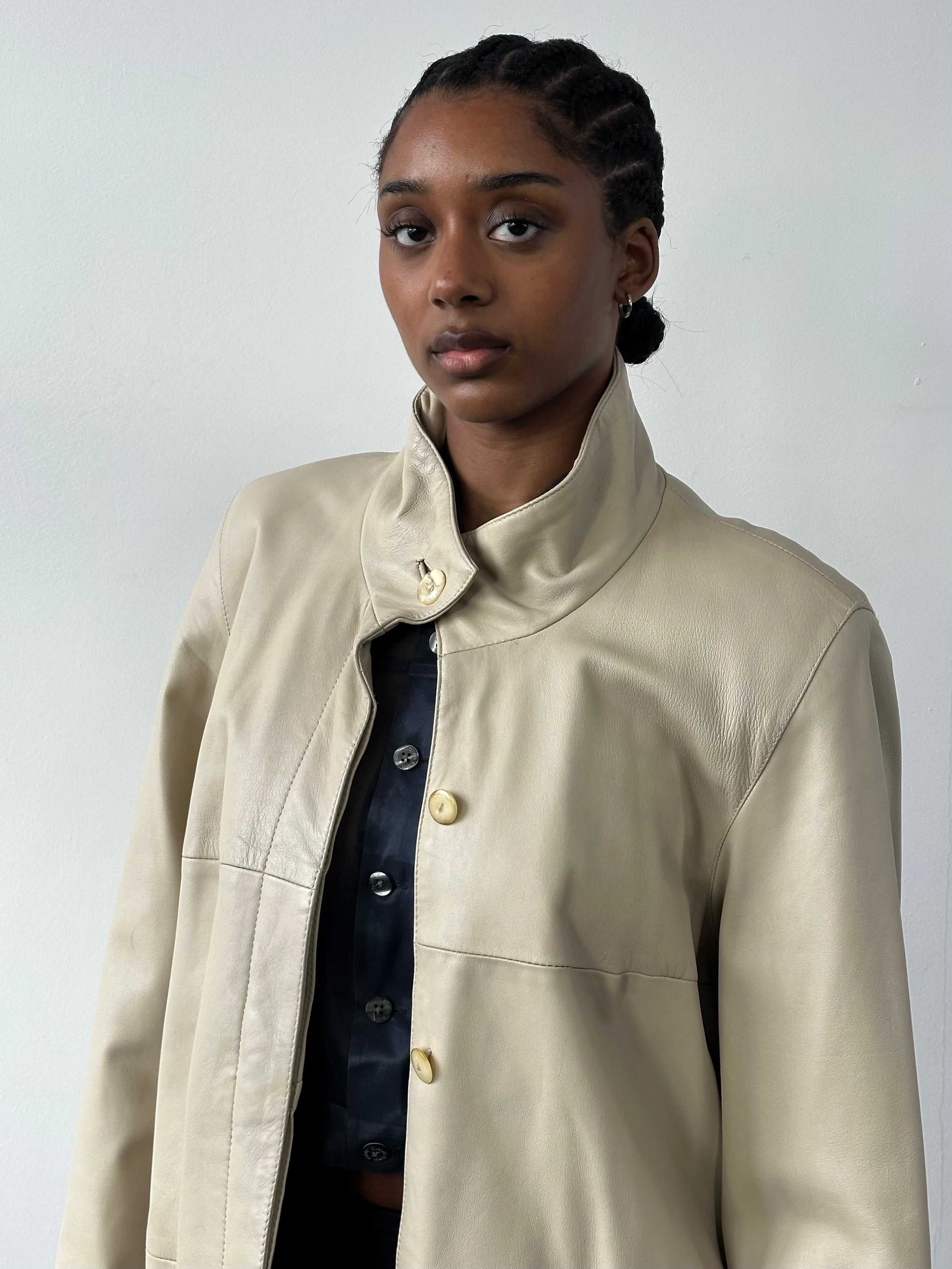 Vintage 1990s high neck leather trench coat, stylish leather jacket with a classic silhouette and vintage detailing.