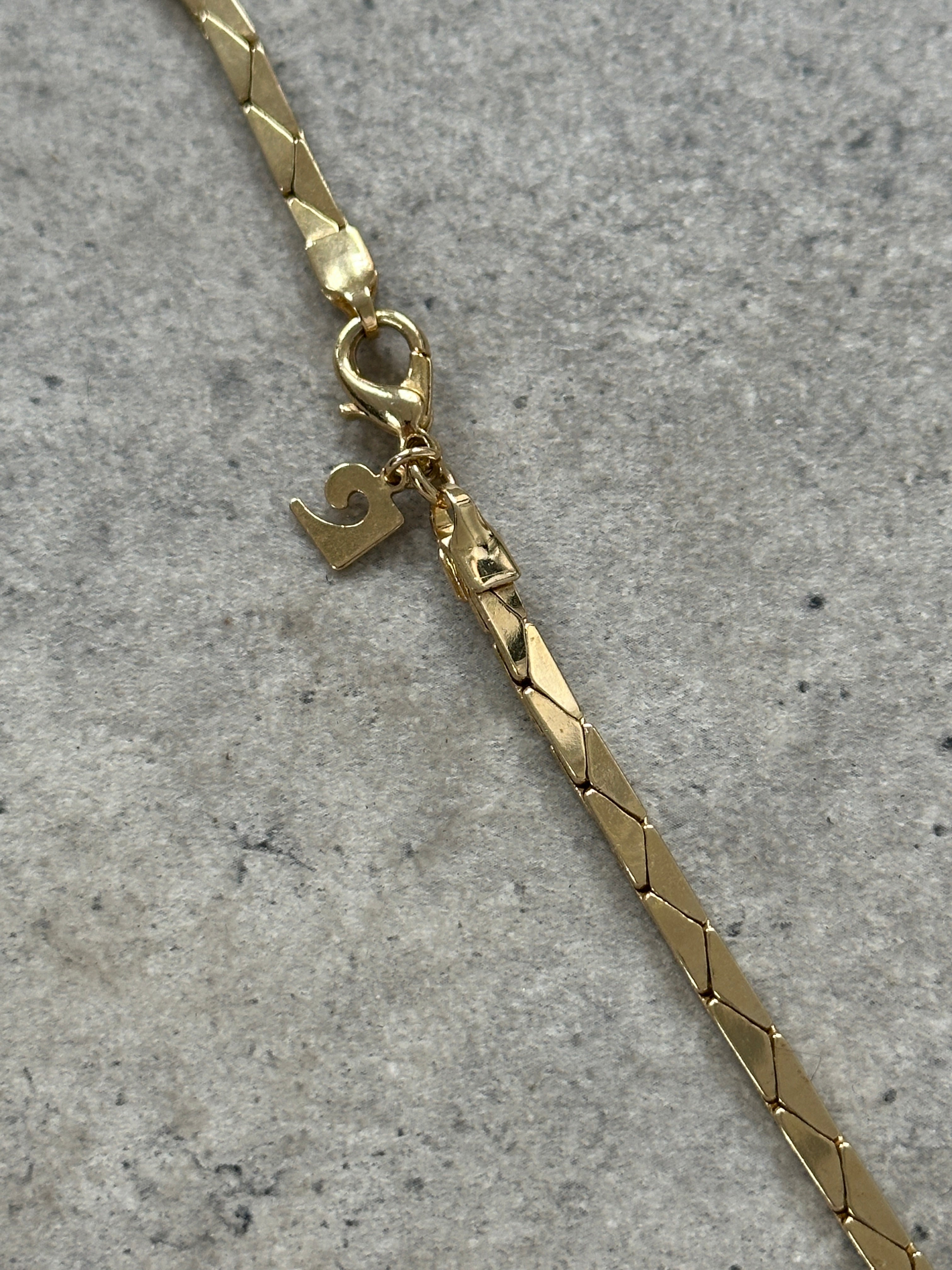 Gold plated Pierre Cardin necklace with delicate chain and subtle pendant, showcasing elegant jewelry design.