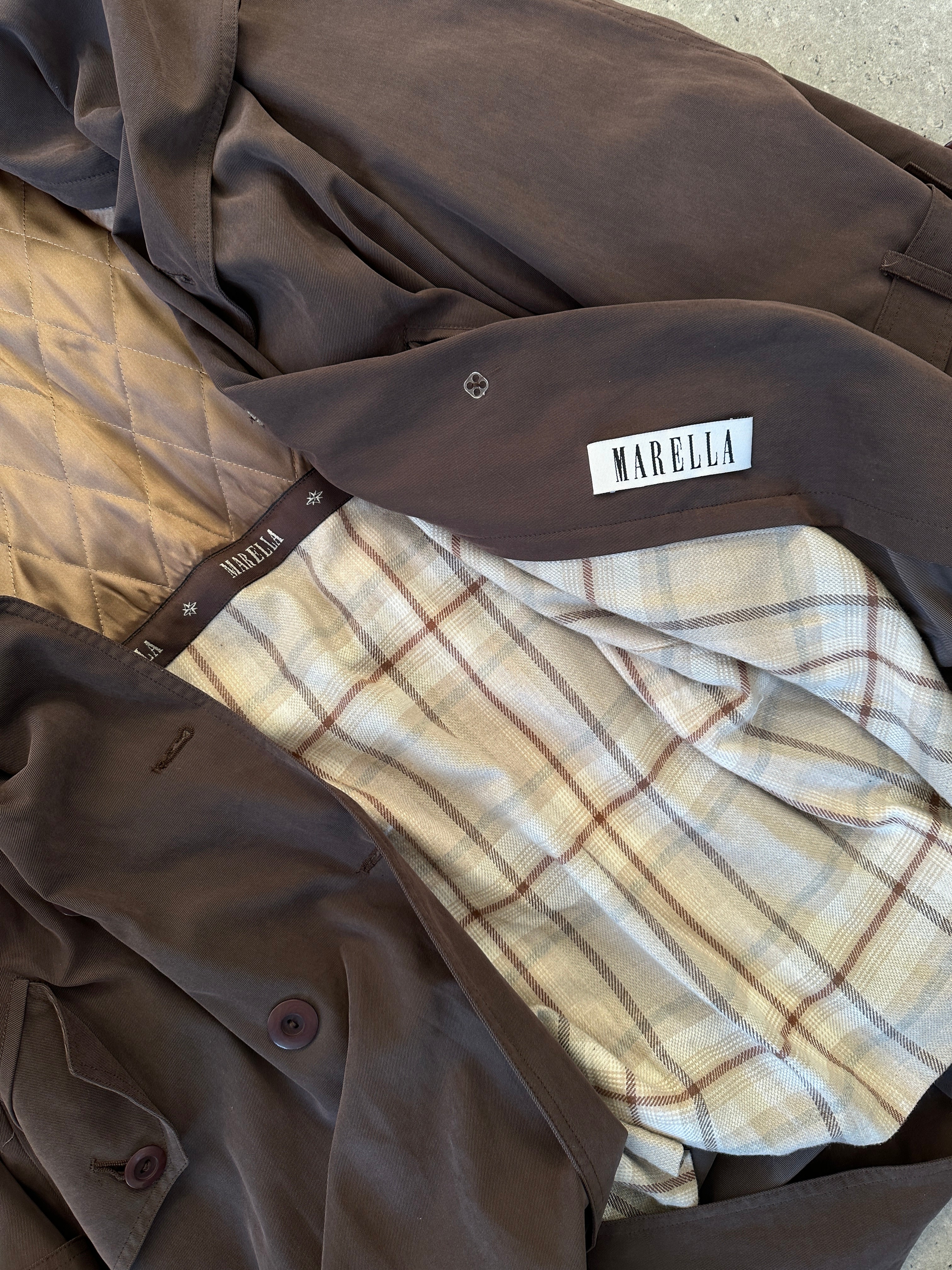 Marella double-breasted belted soft touch trench coat in beige, featuring a classic collar and button details, displayed on a hanger.