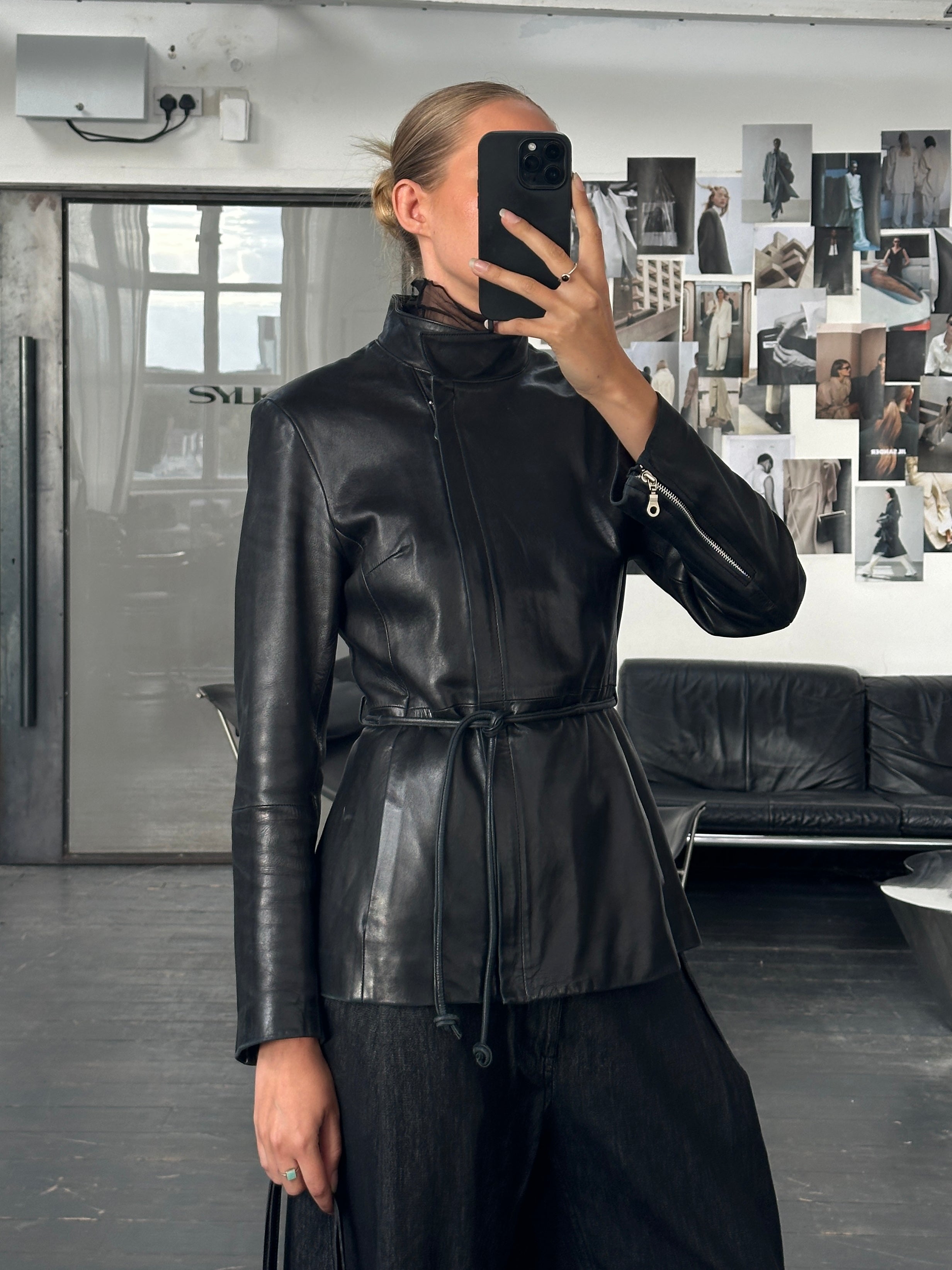 Vintage French 1990s high neck leather jacket with tie belt, featuring a classic design and timeless style in a size S/M.