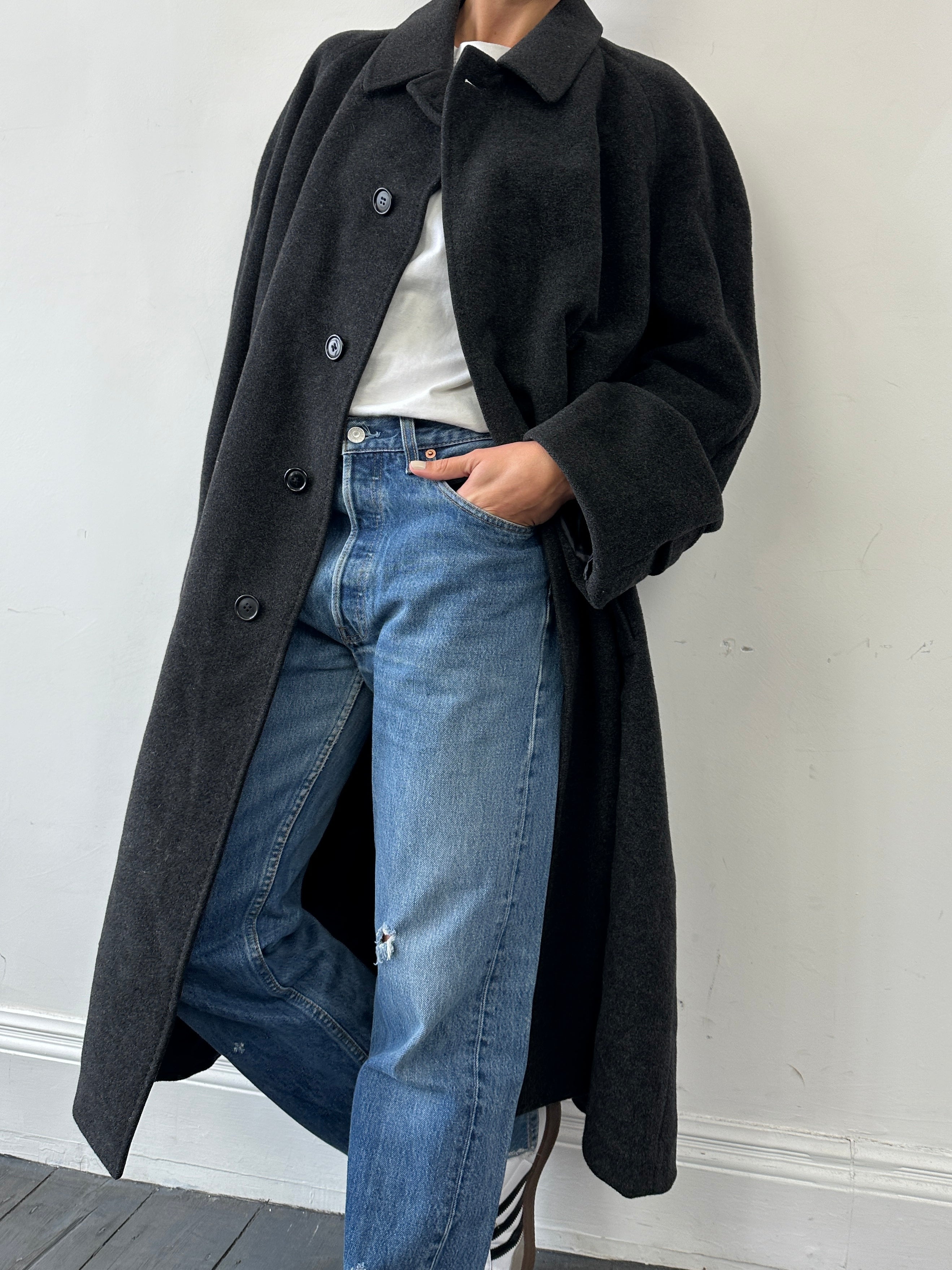 Levi’s 501 mid wash distressed straight leg denim jeans with fading and rips, shown on a model's lower body in size W30.