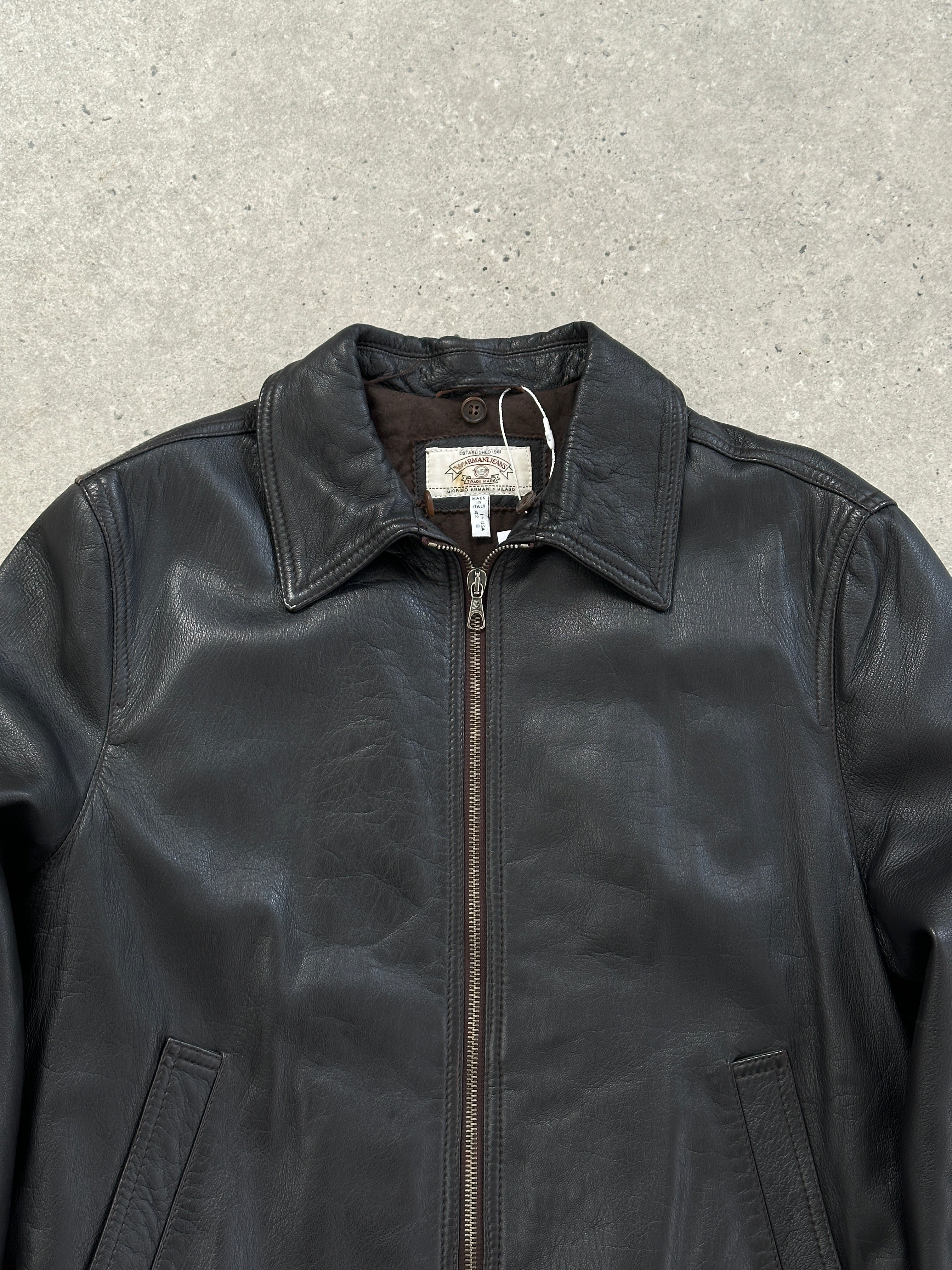 Armani Jeans leather jacket in size S/M, black fashion outerwear with classic design and visible leather texture.