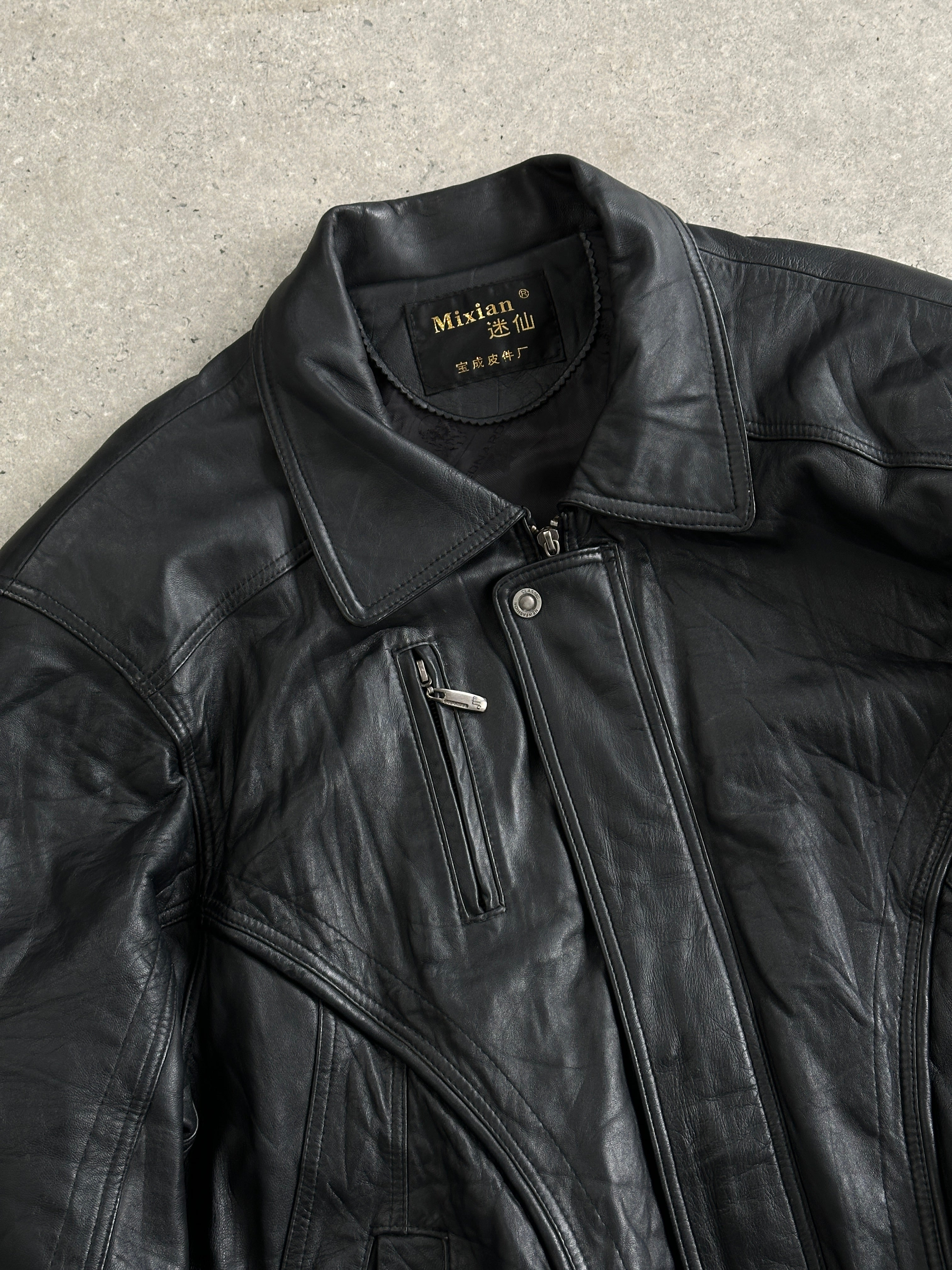 Vintage leather bomber jacket in XL size, featuring classic design and durable construction, displayed on a hanger.