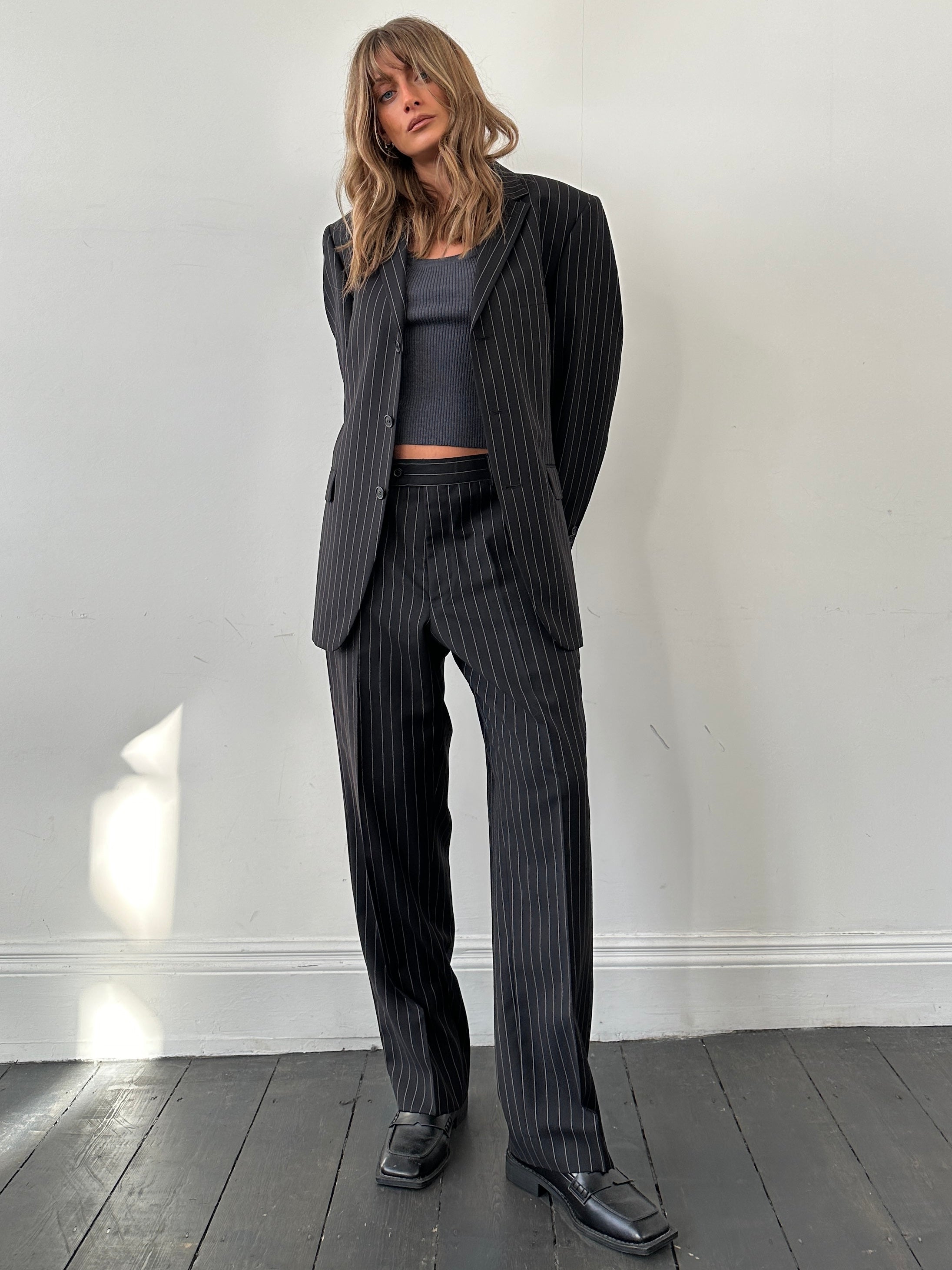Yves Saint Laurent pinstripe wool jumpsuit in size 40S/W34, featuring tailored fit and classic pinstripe pattern.