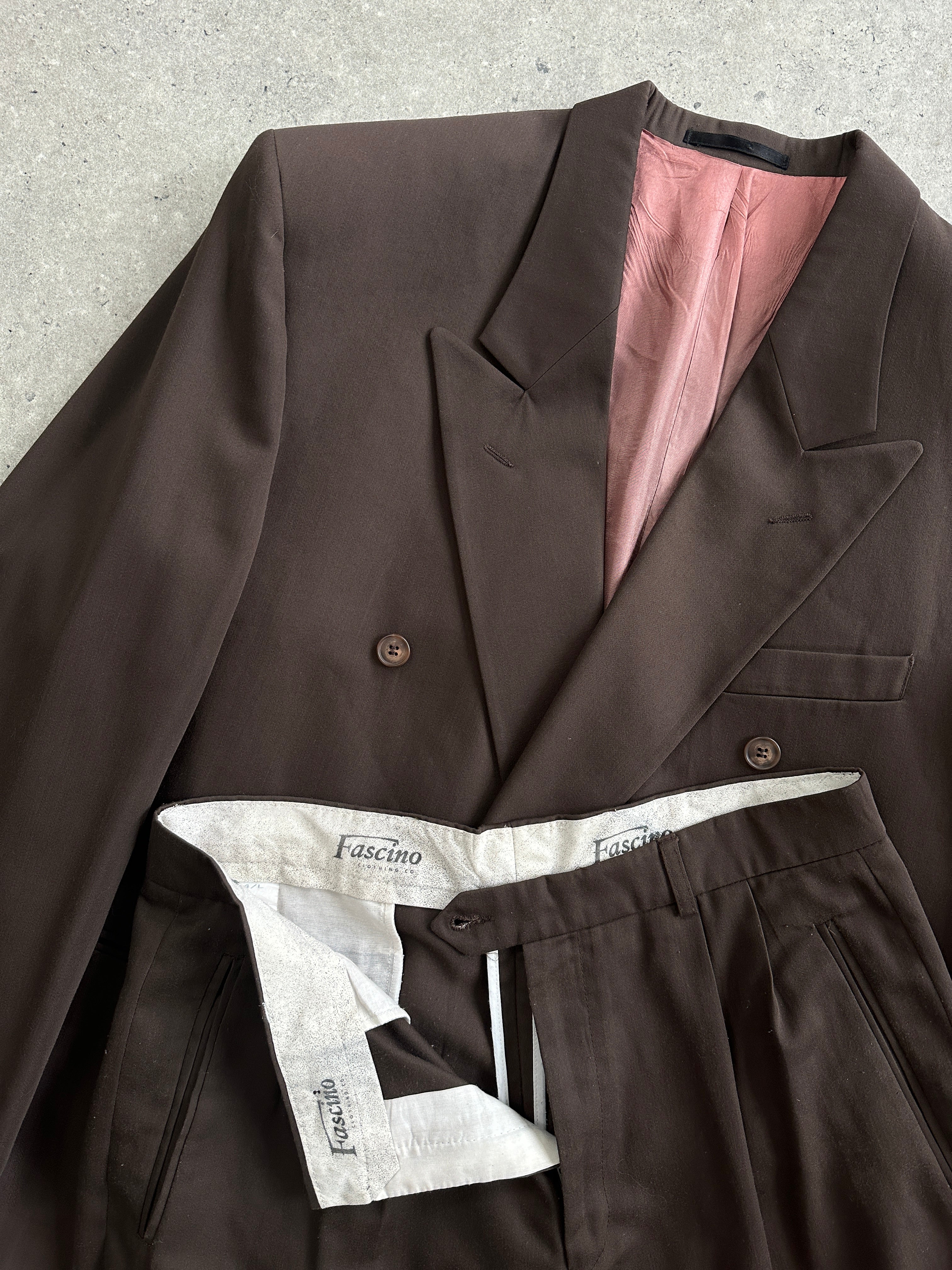 Vintage double-breasted jumpsuit in size 40R/W32, featuring classic lapels and tailored fit, displayed on a hanger.