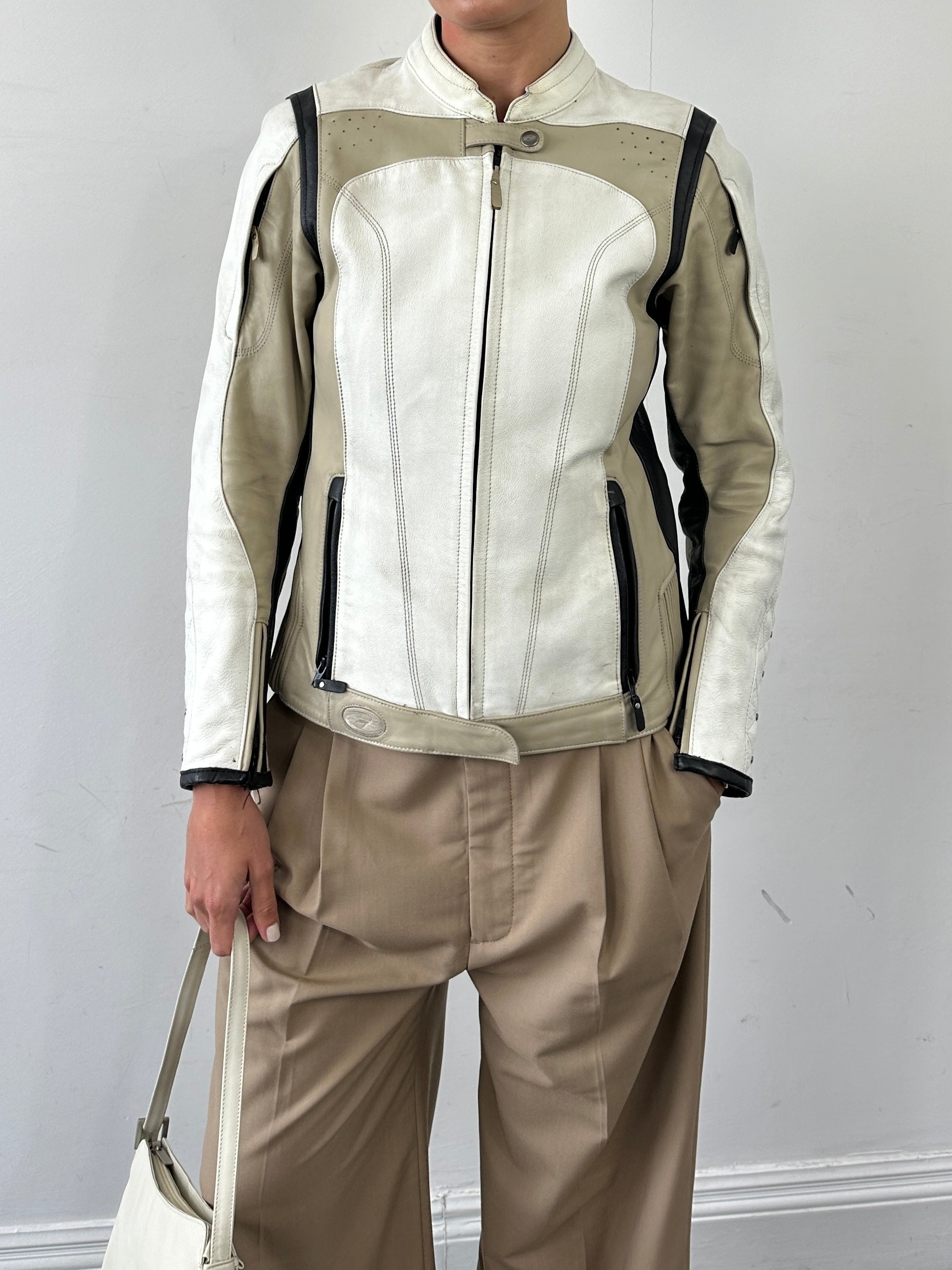Vintage men's leather motorcycle jacket with classic design, black leather, and zipper details, size small/medium.