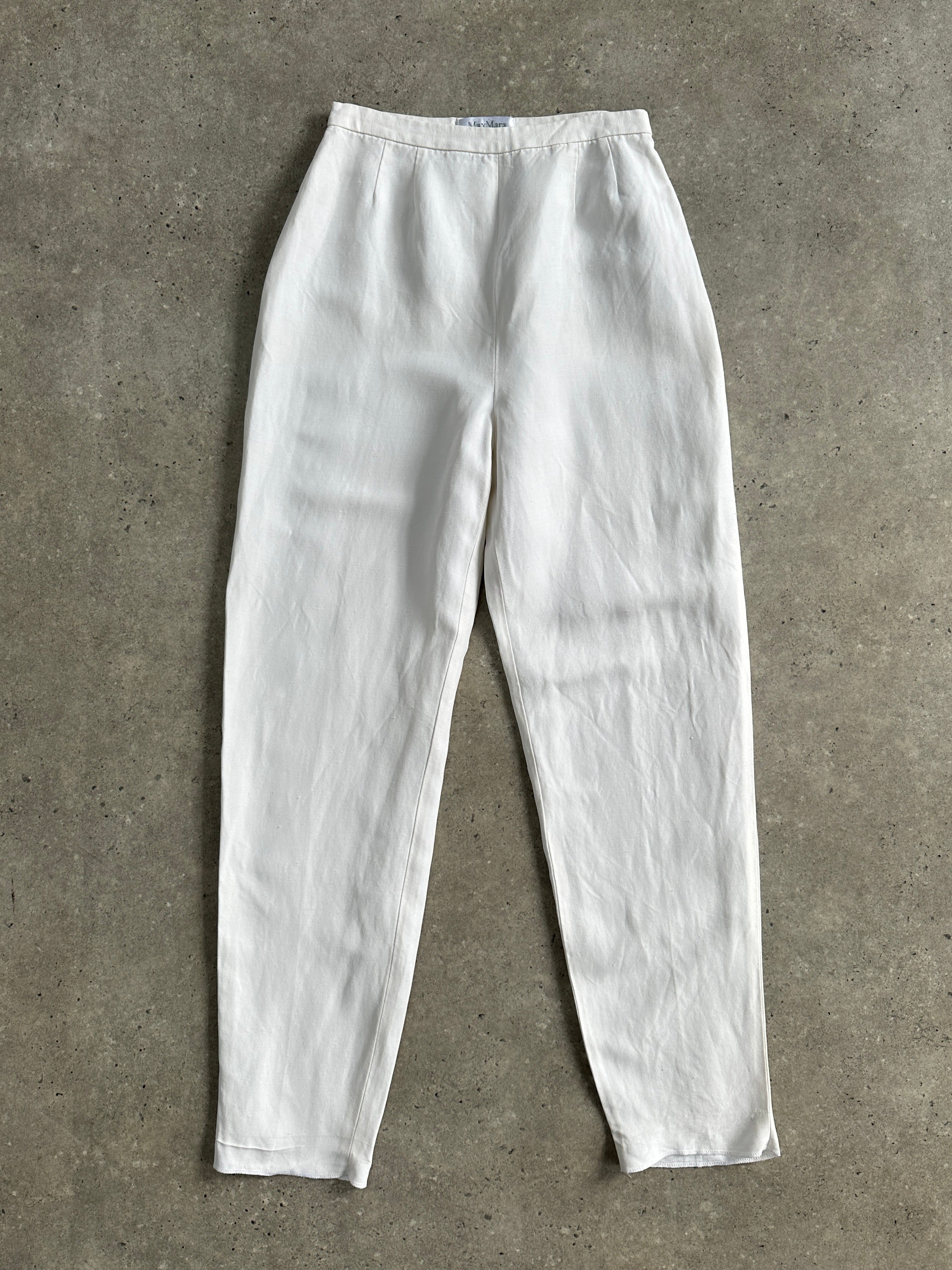 Max Mara linen tapered leg high-waisted trousers in neutral fabric, displayed on a hanger.