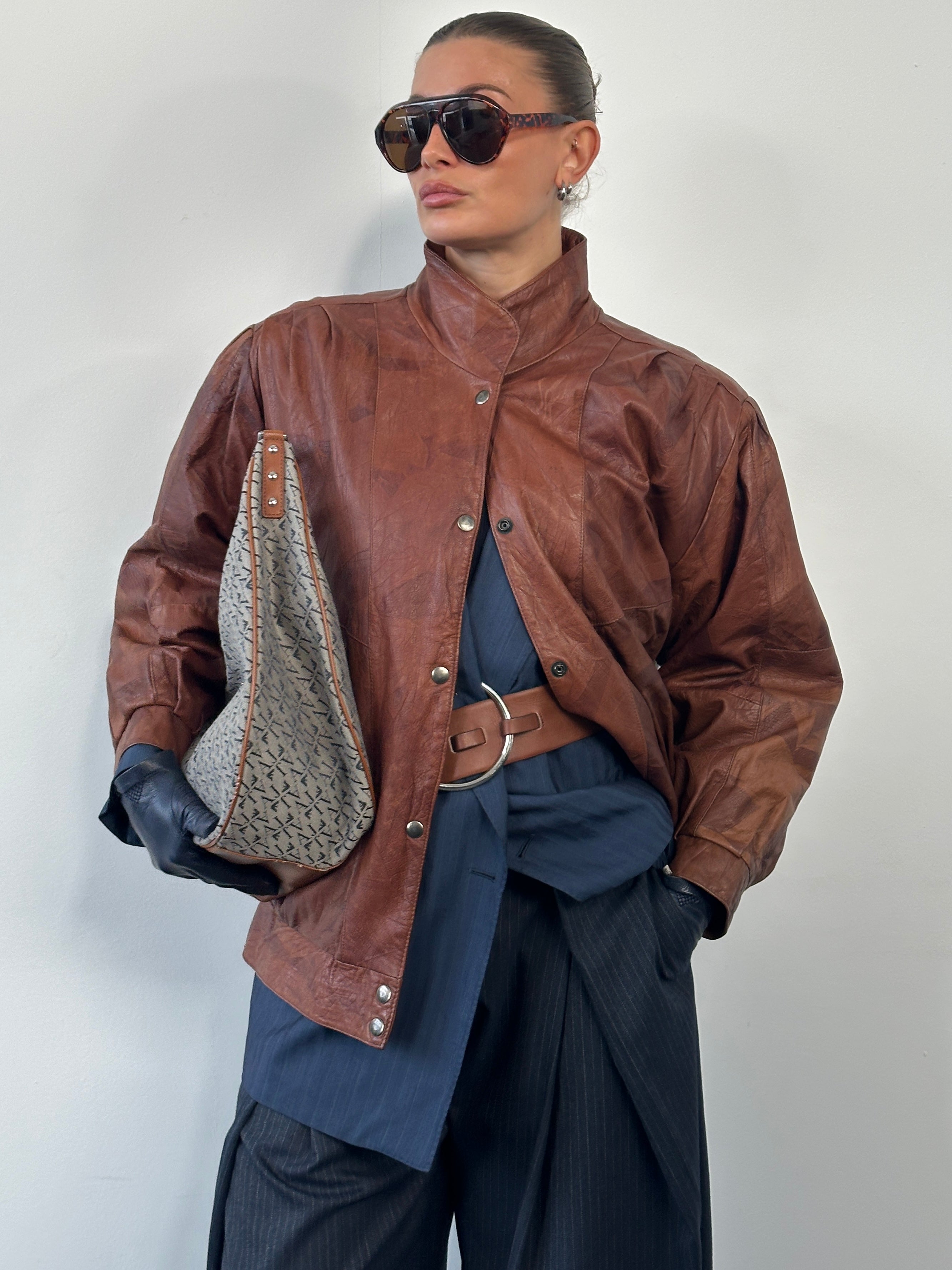 Vintage 1980s high neck leather bomber jacket in size large, featuring classic black leather and vintage-style design.