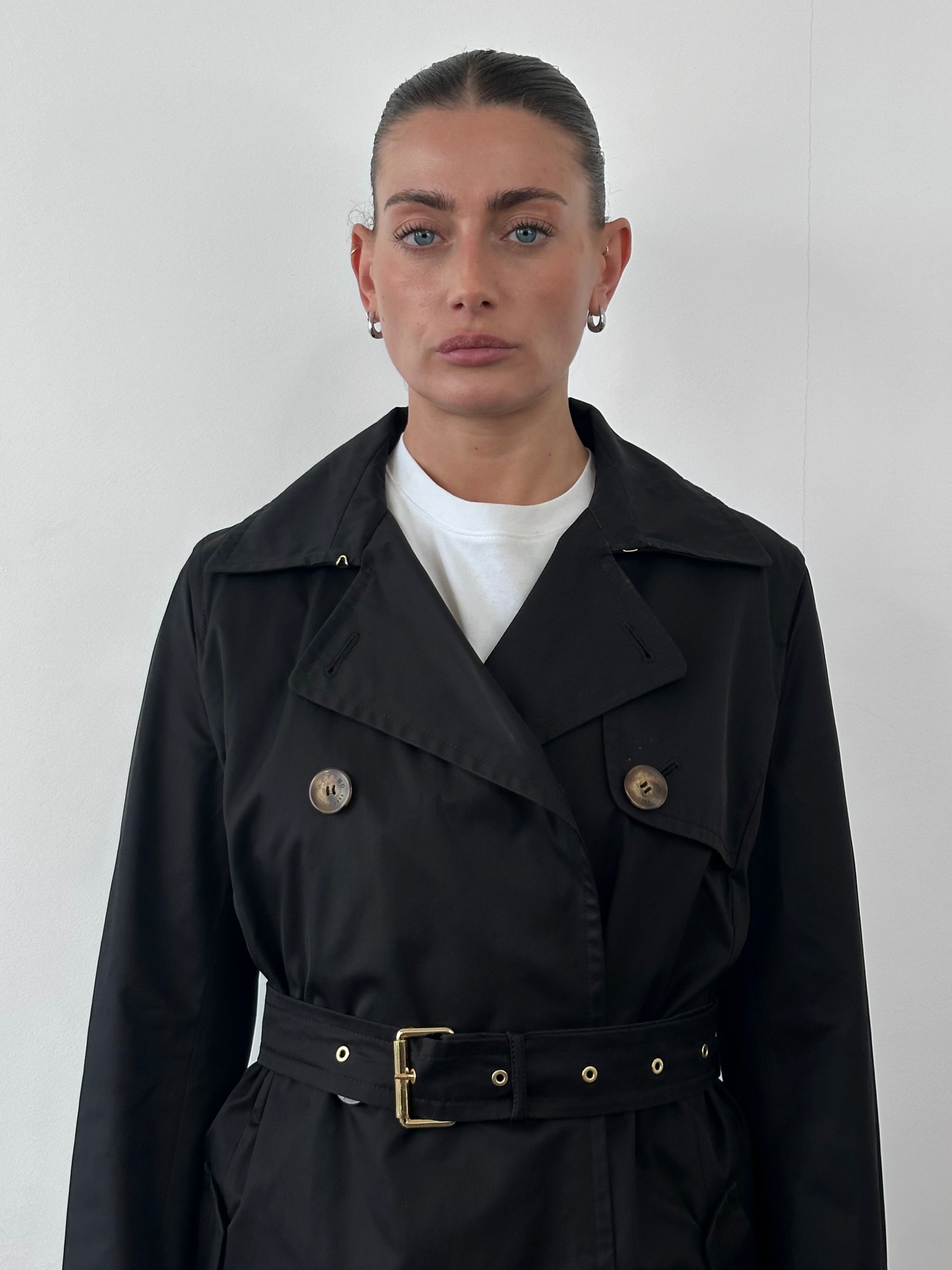 Max Mara Weekend cotton belted trench coat in beige, featuring a classic design with buttons and a waist belt.