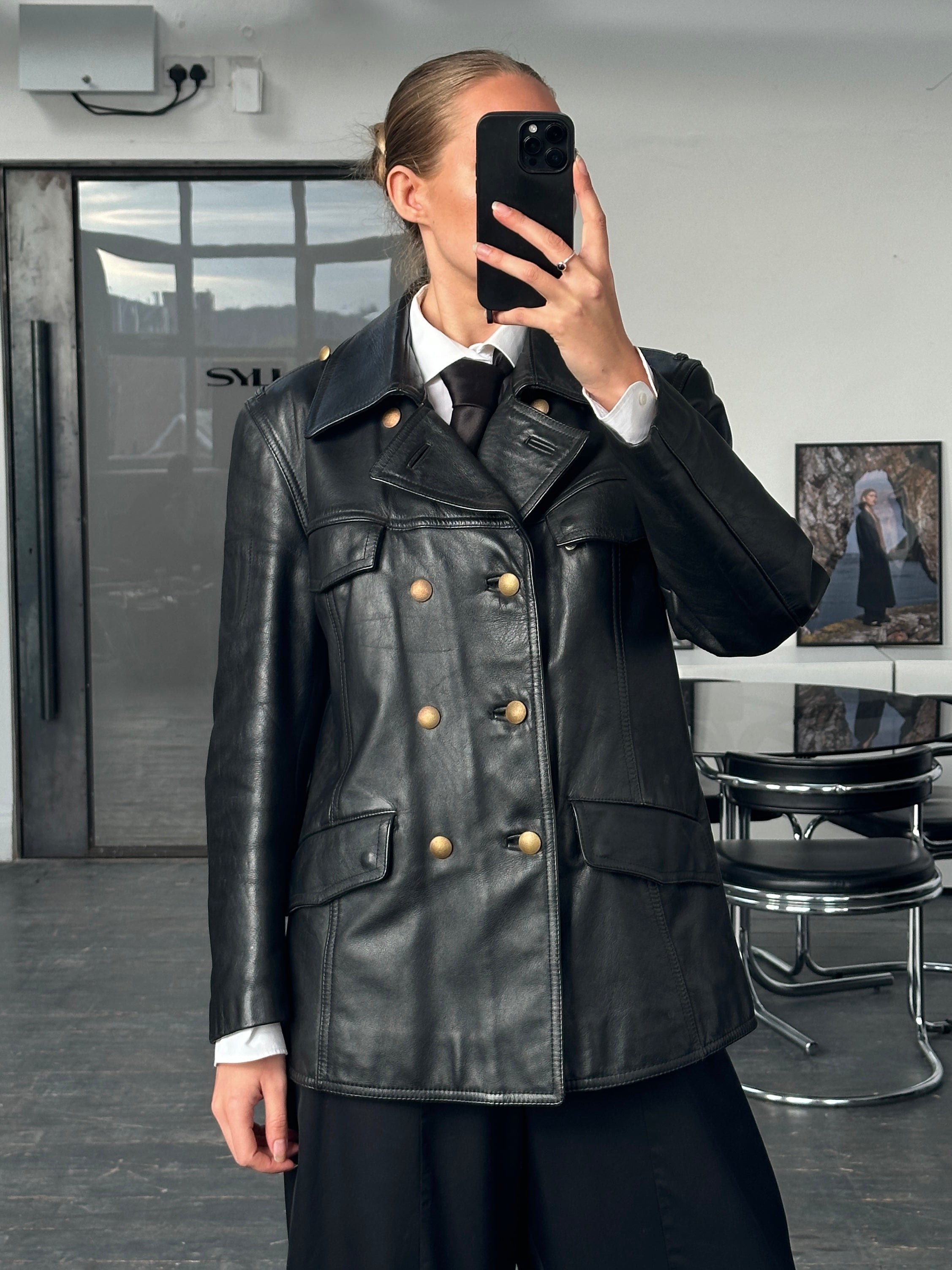 Vintage 1980s double-breasted military leather jacket in black, featuring structured design and classic details.