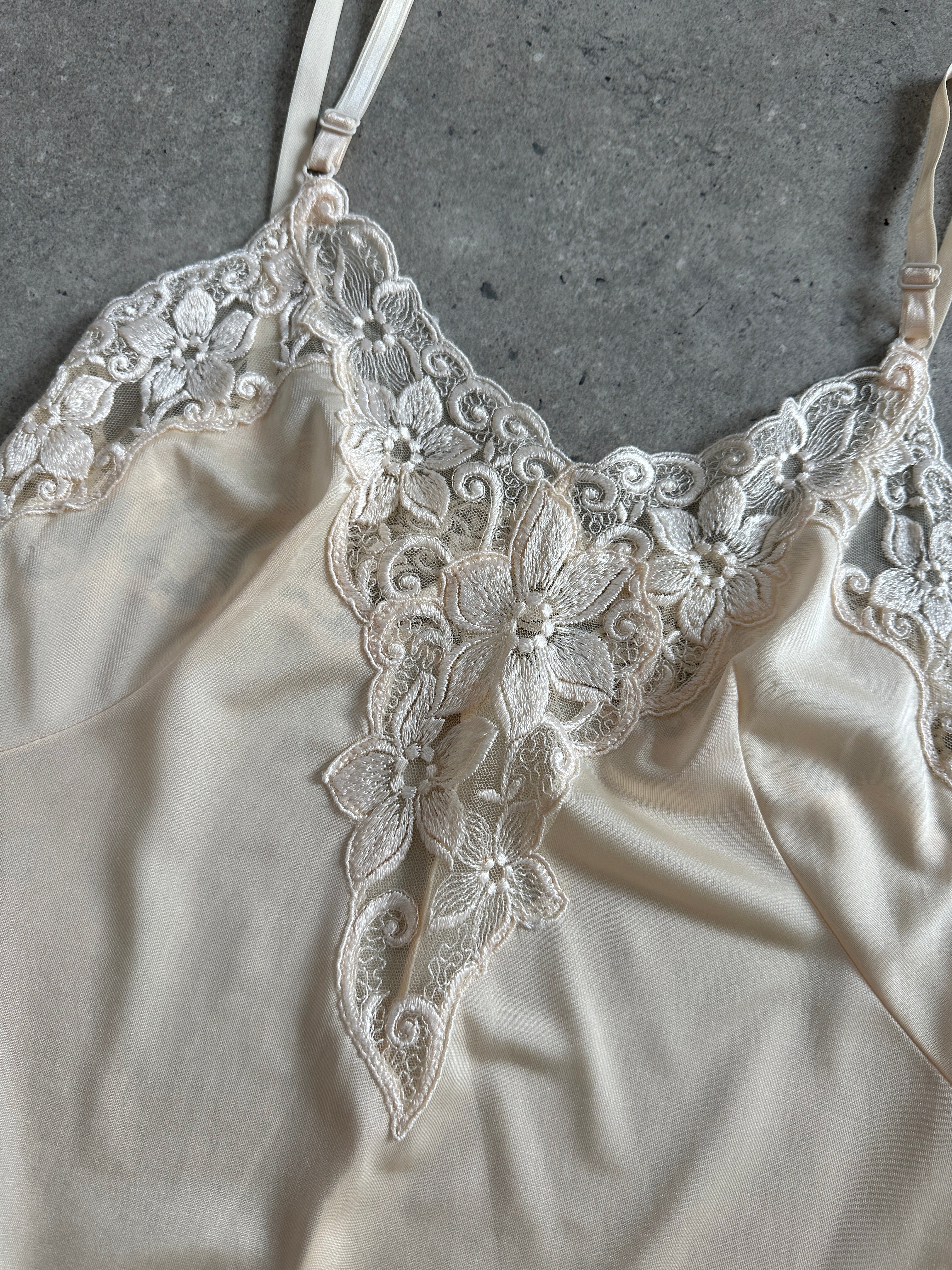 Vintage 1990s lace sheer mini slip dress in XS/S, featuring delicate lace fabric and vintage style, perfect for retro fashion.