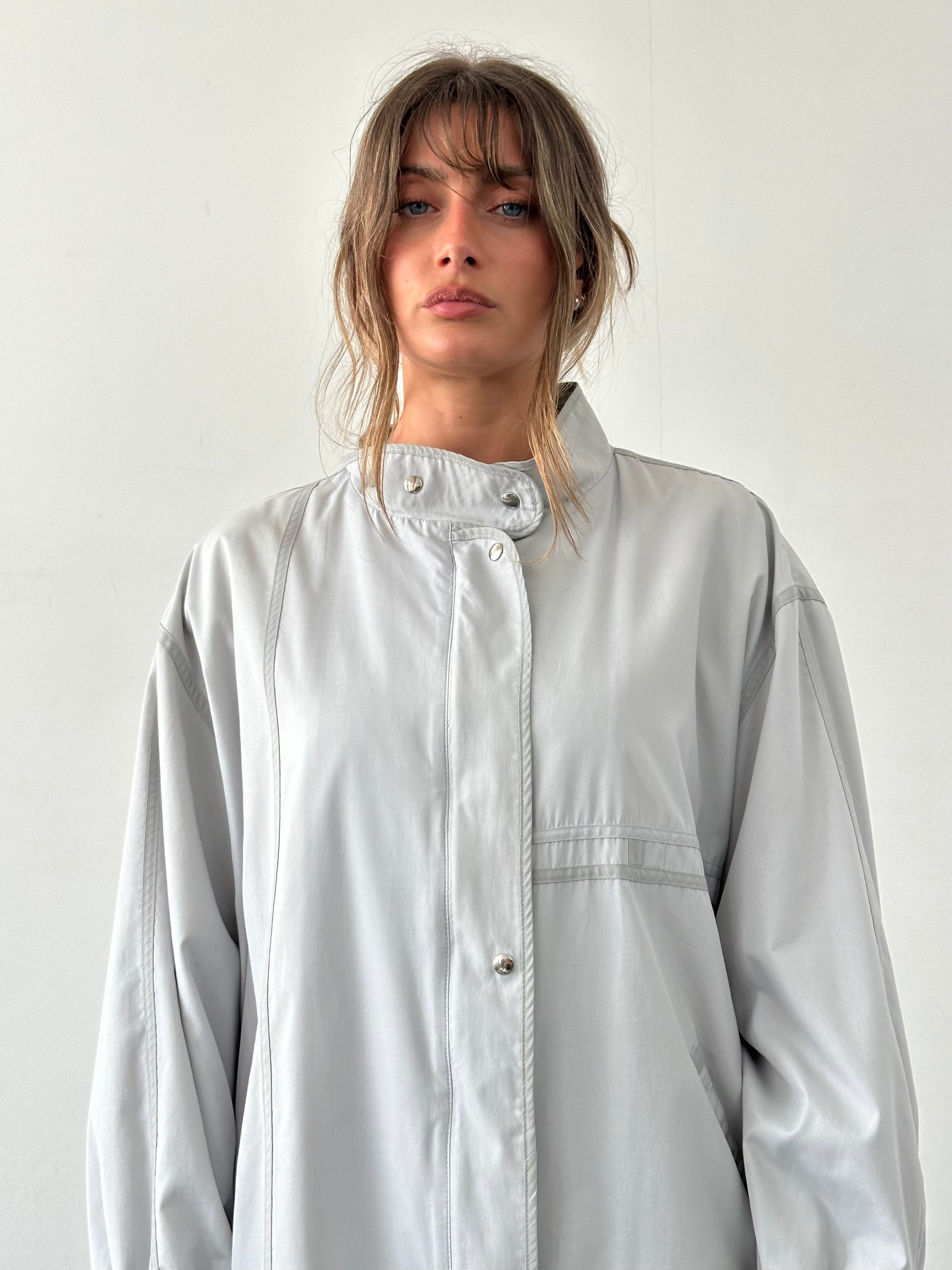 Vintage 2000s high neck bomber jacket in XL style, featuring classic design and durable fabric, displayed on a hanger.