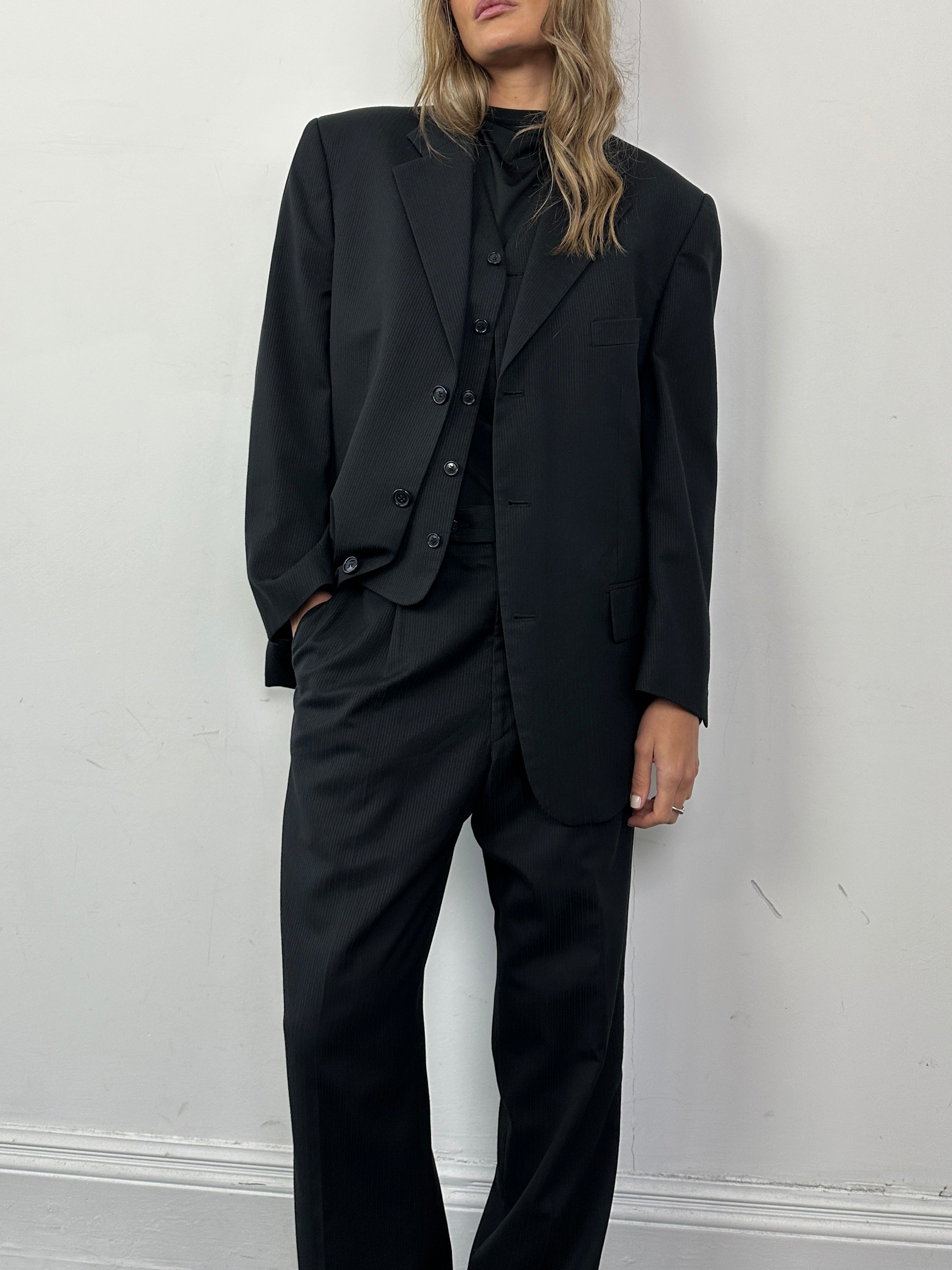 Vintage wool ribbed three-piece suit featuring a tailored blazer, vest, and trousers in a classic style.