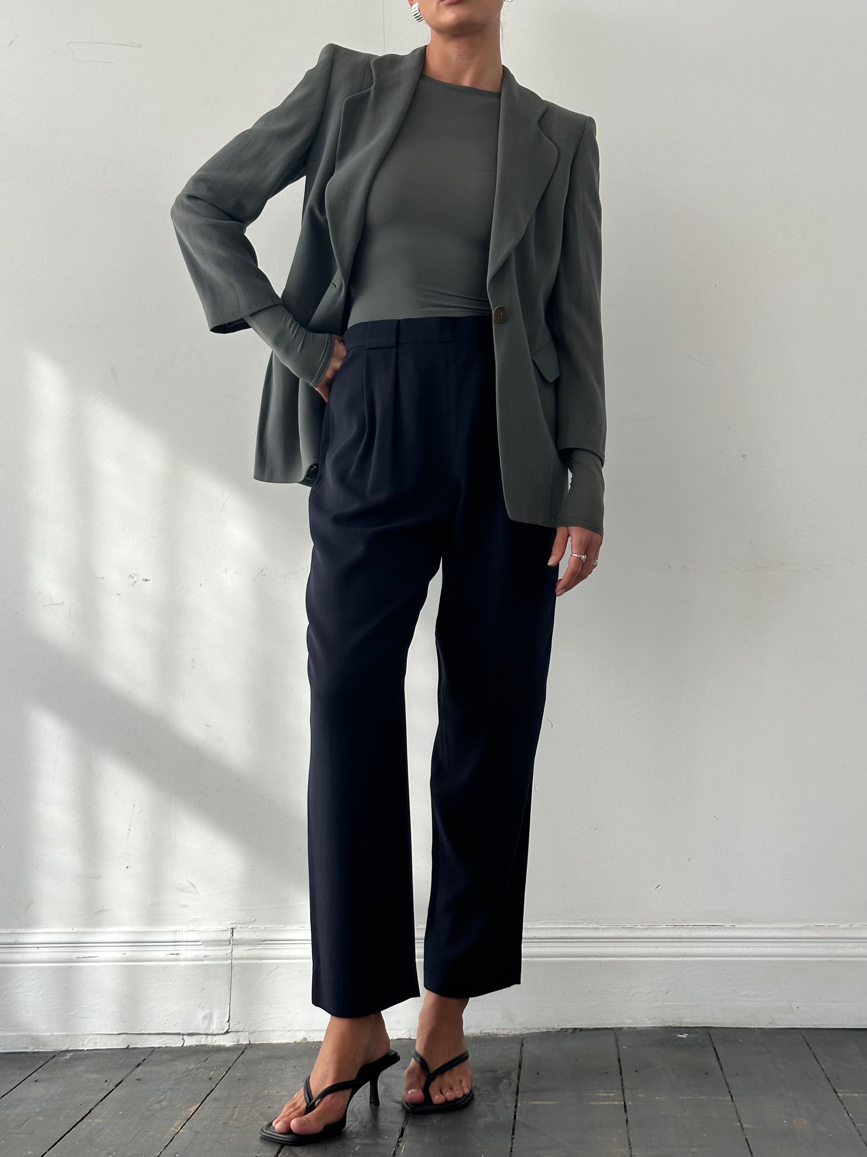 Giorgio Armani 1990s high-waisted pure wool tapered trousers in size W28, shown in natural fabric and classic fit.