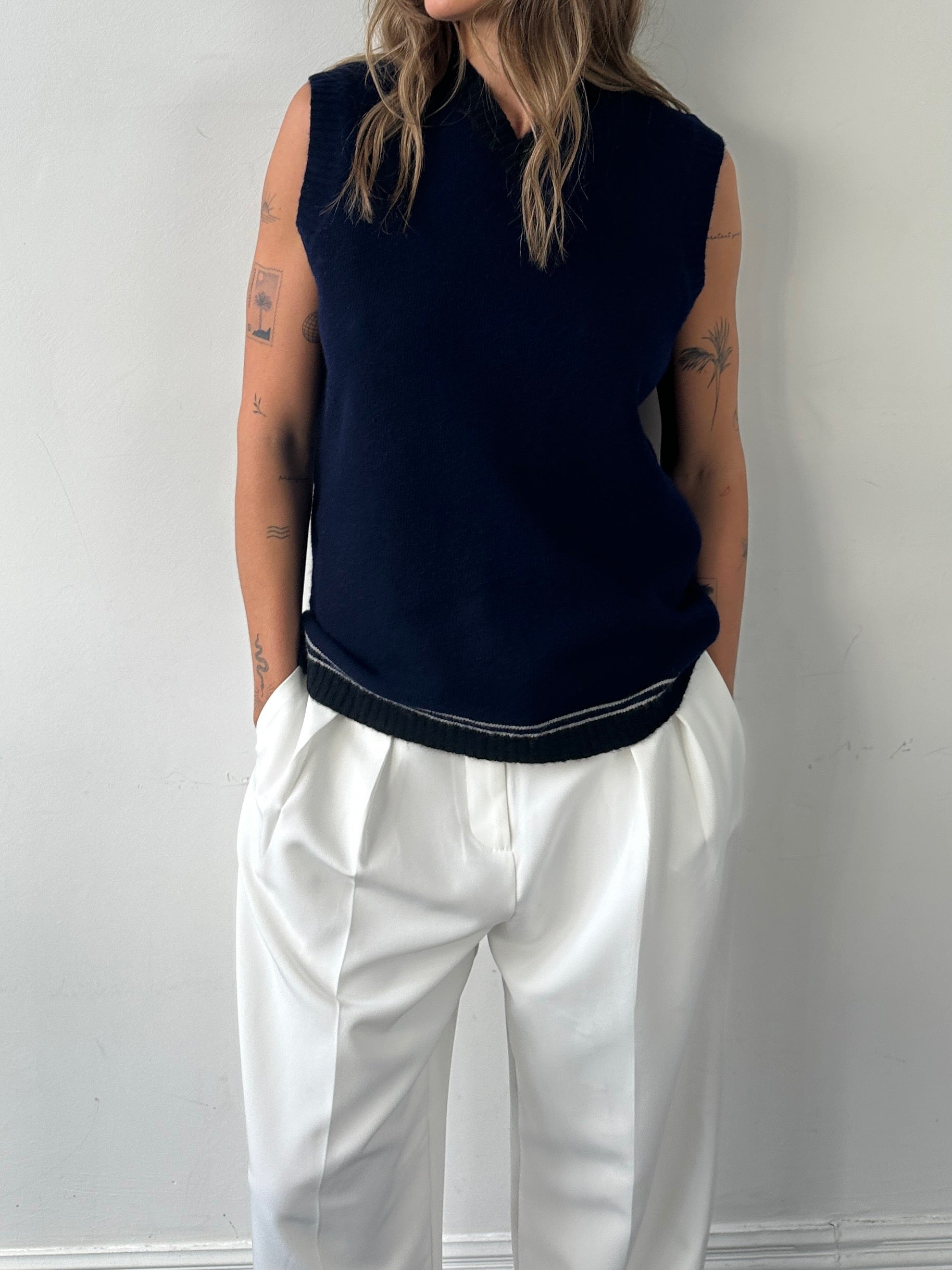 Vintage pure lambswool V-neck sleeveless vest jumper in size M, showing a close-up of the classic knit texture and deep V-neck design.