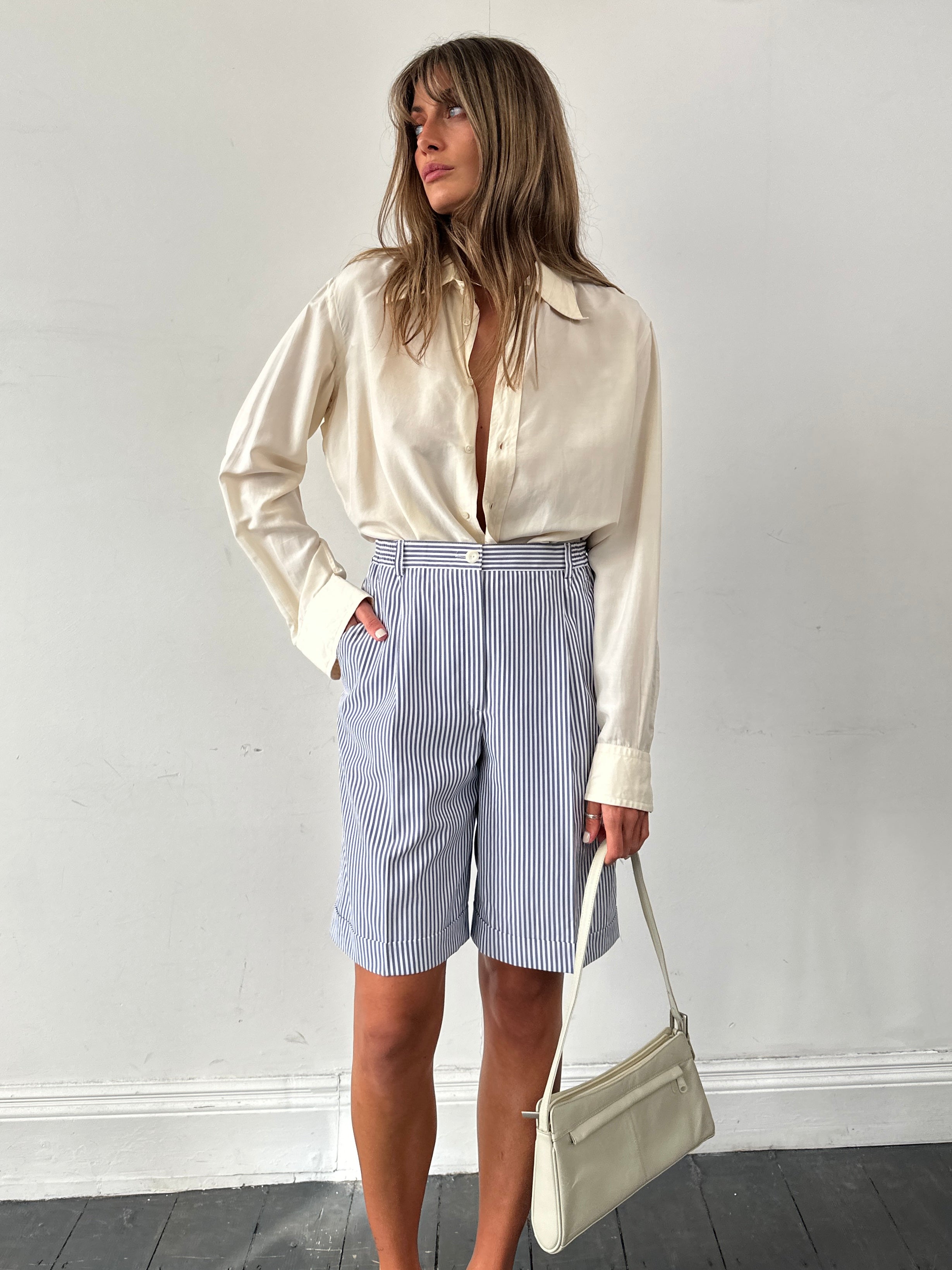 Vintage brand vintage stripe pleated shorts in size W28, featuring colorful striped pattern and tailored pleats.