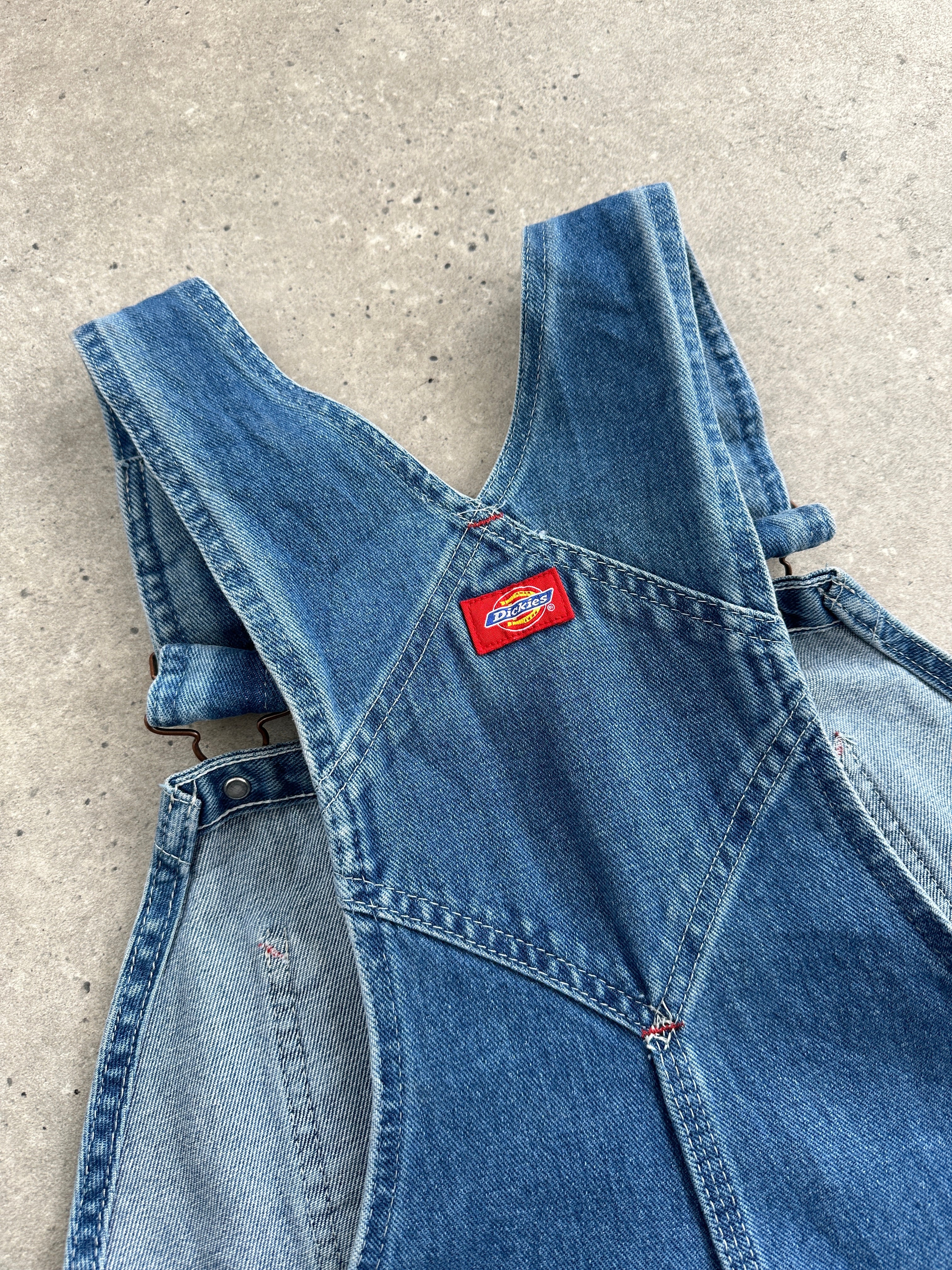 Dickies pure cotton denim dungarees in size M, featuring classic blue denim with adjustable straps and front pockets.