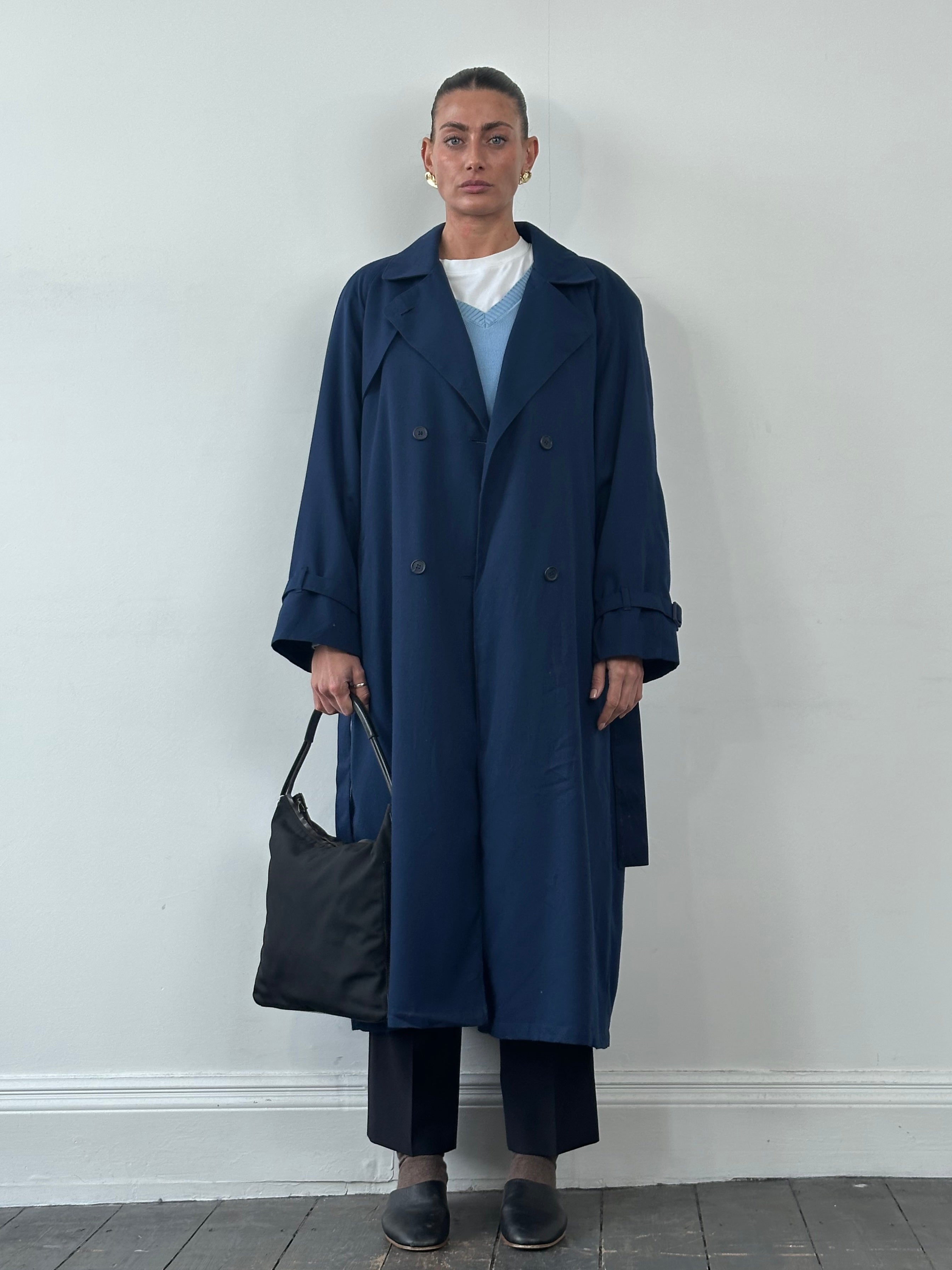 London Fog wool belted trench coat in XL, shown hanging with classic double-breasted design and waist belt for a tailored look.