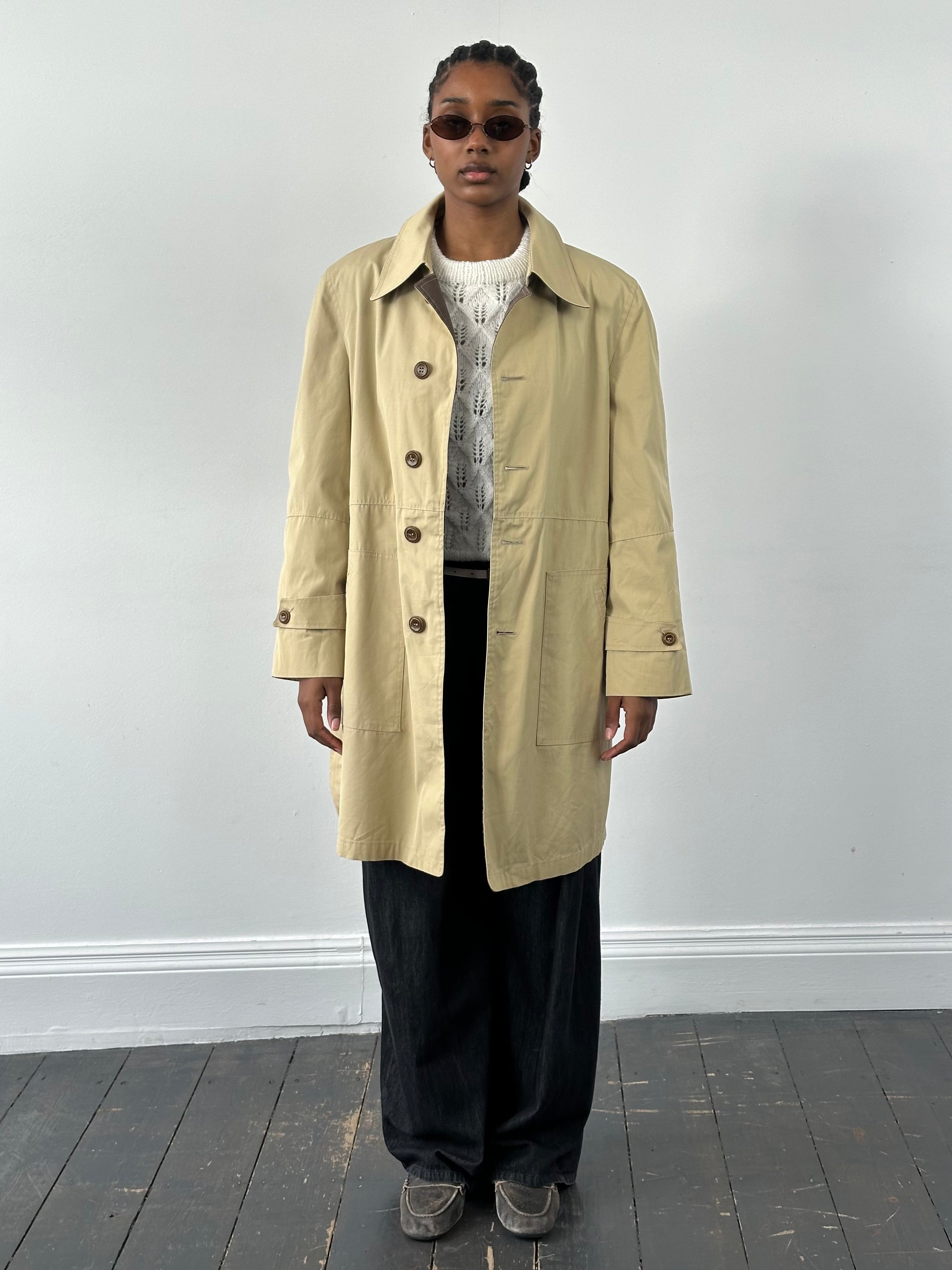 Christian Dior Paris 1980s cotton belted trench coat shown in beige with classic double-breasted style and waist belt.