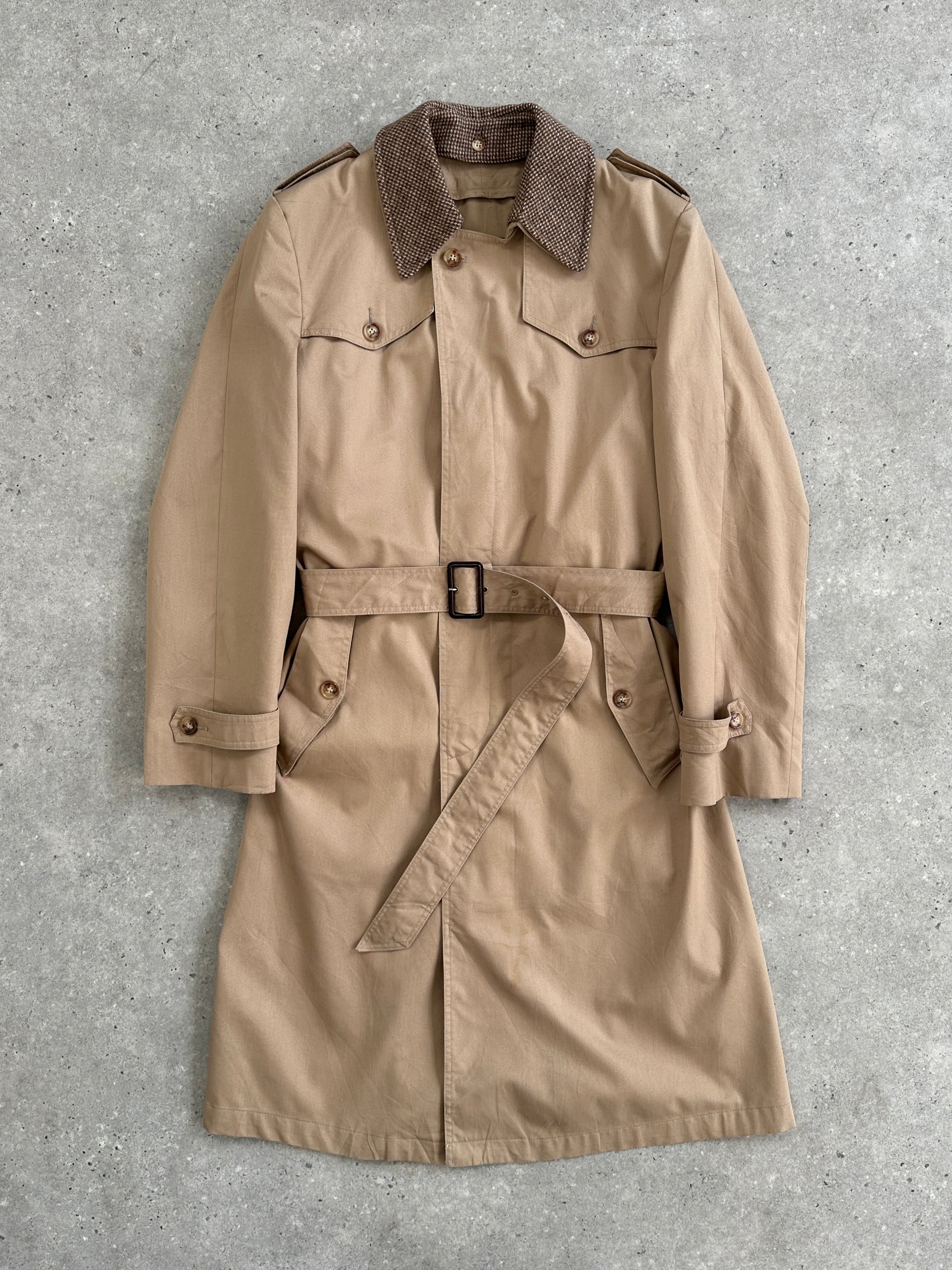 Christian Dior Monsieur cotton single-breasted belted trench coat displayed on a hanger, showcasing its classic design and beige color.