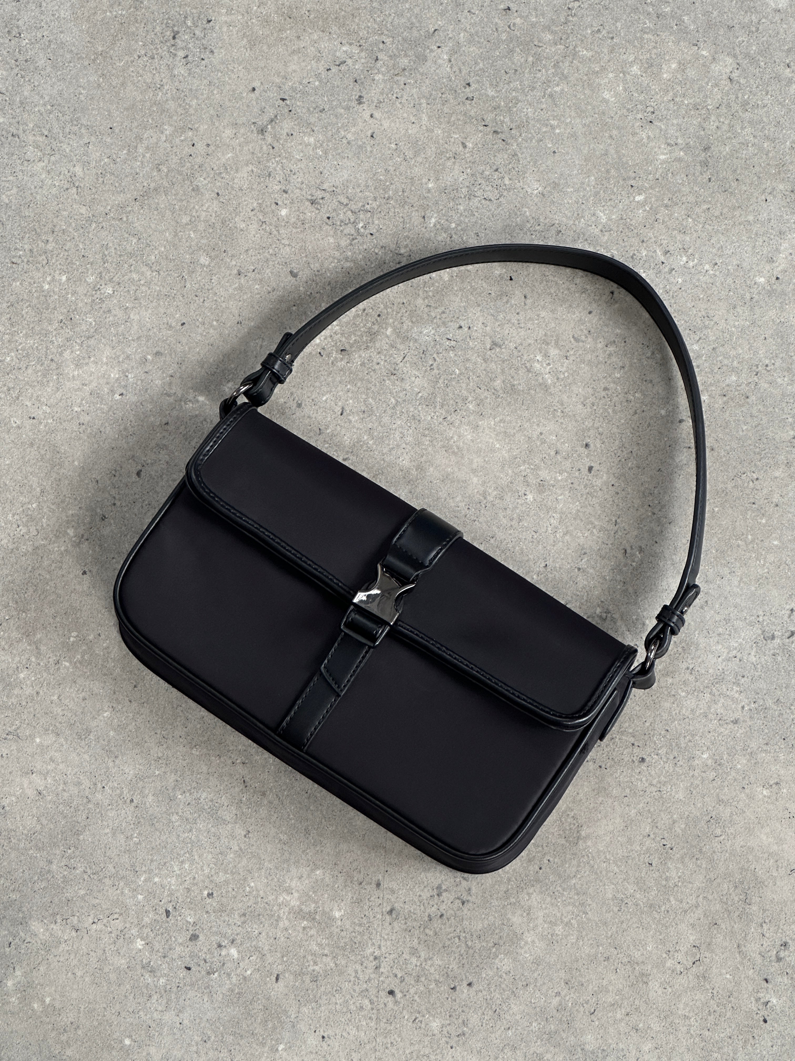 Pierre Cardin nylon hardware shoulder bag with adjustable strap and stylish design, featuring metal hardware accents.