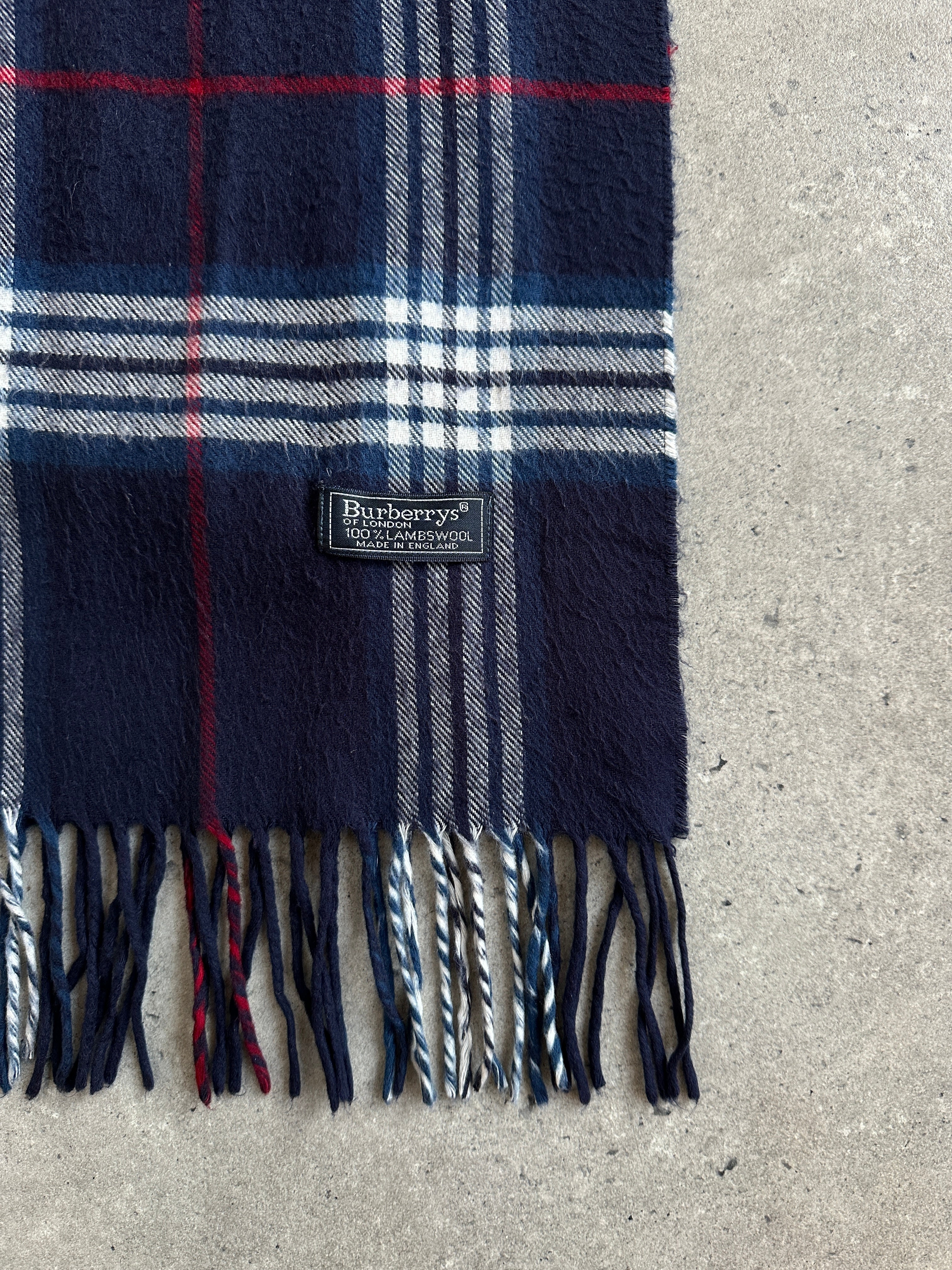 Burberry 1990s check lambswool scarf with classic plaid pattern and fringed edges, styled for a timeless look.