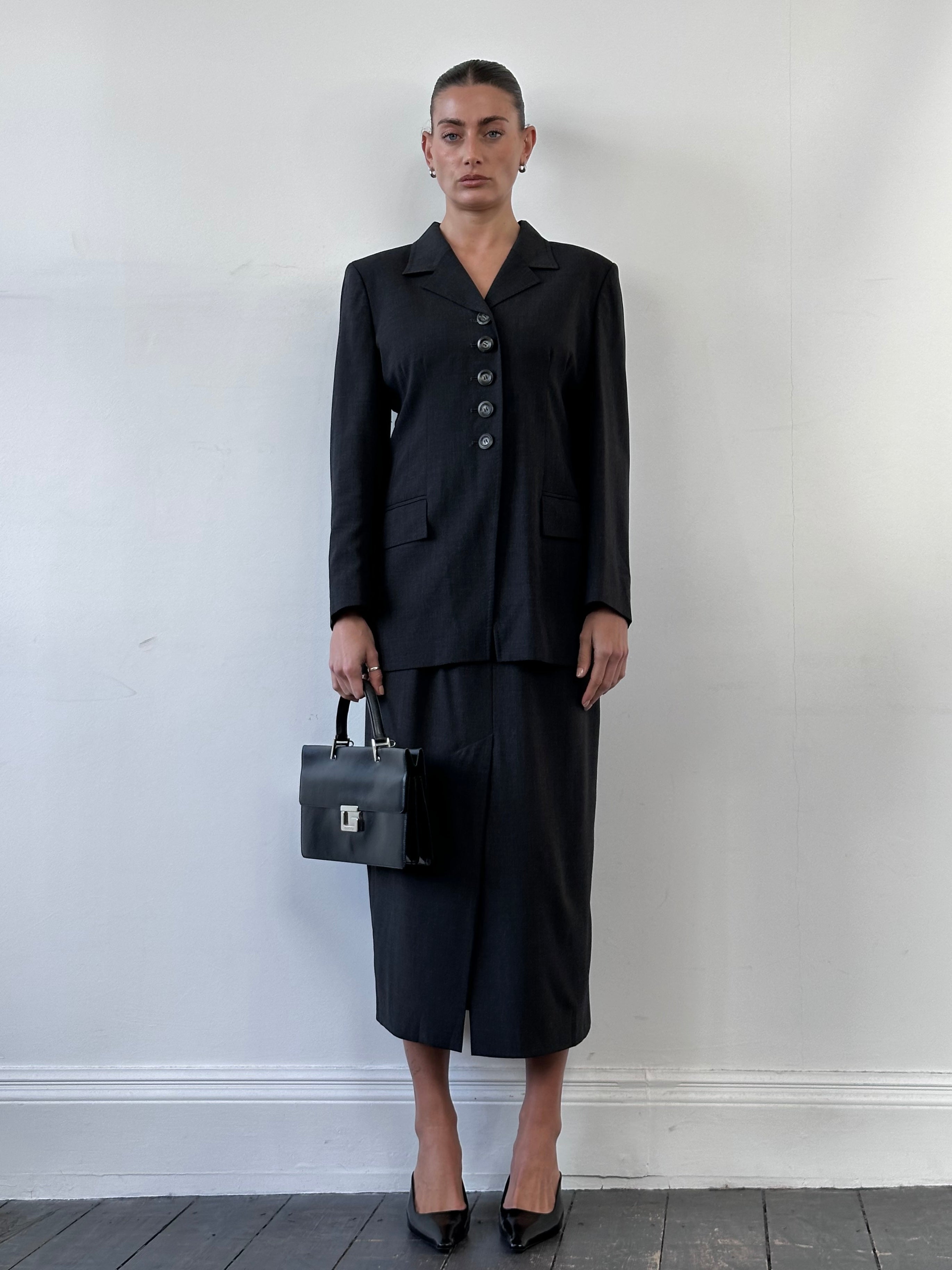 Jaeger 1990s pure wool two-piece skirt suit, featuring a tailored blazer and matching pencil skirt in classic wool fabric.
