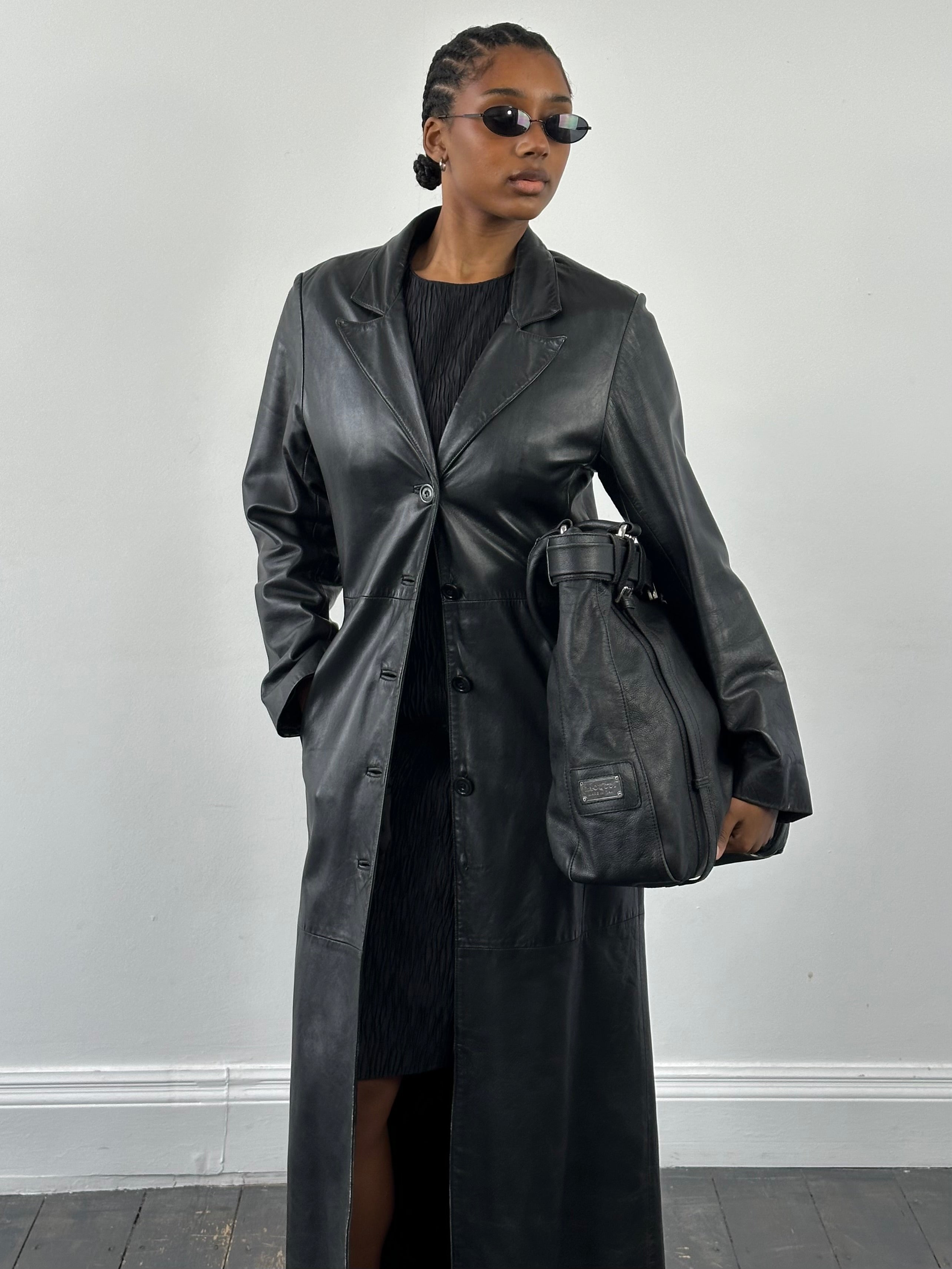 Vintage 1990s floor-length leather trench coat, S/M, stylish leather jacket with classic design and aged leather appearance.