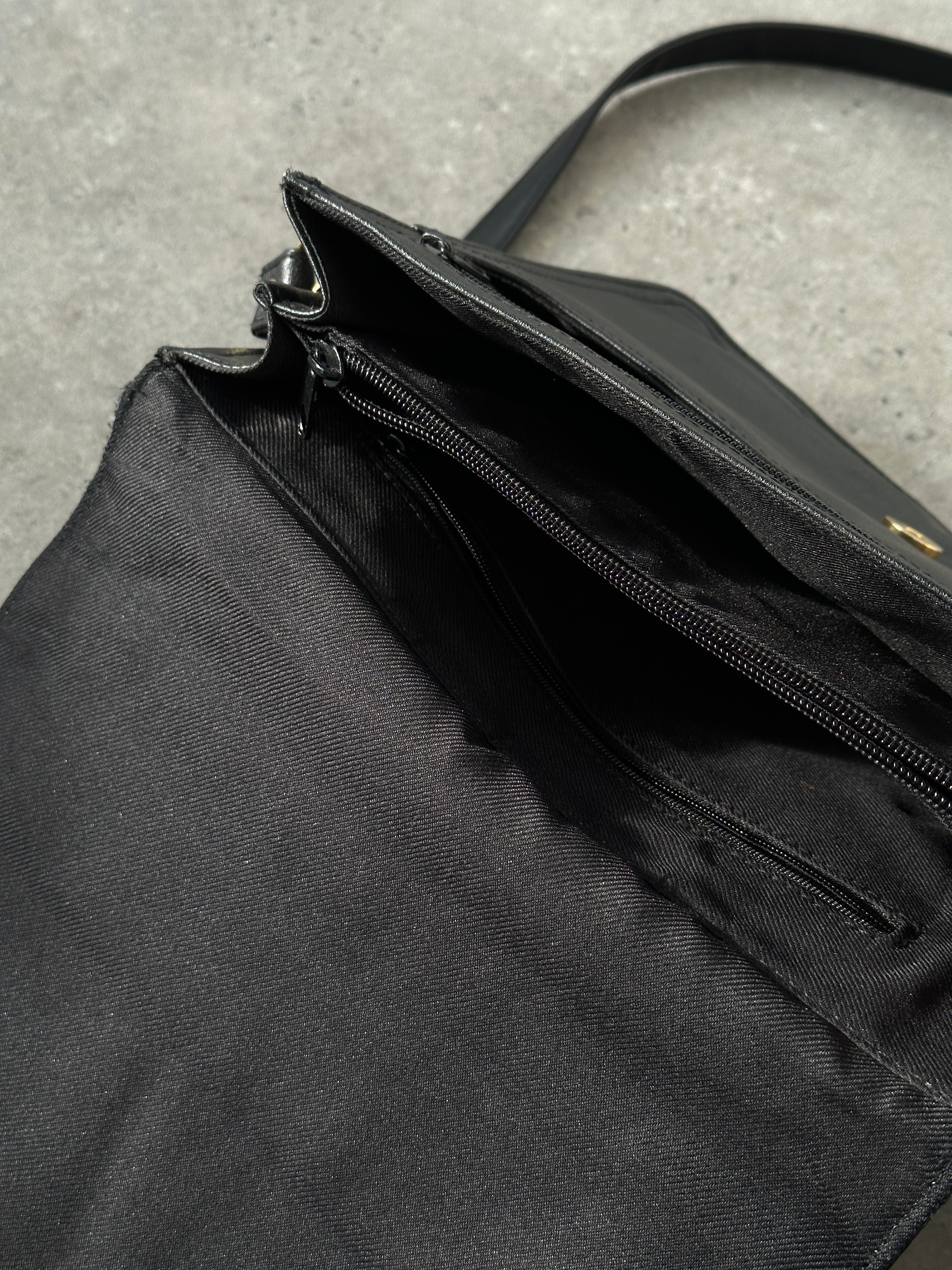Vintage faux leather crossbody bag with adjustable strap and classic design, featuring a textured surface and silver hardware.