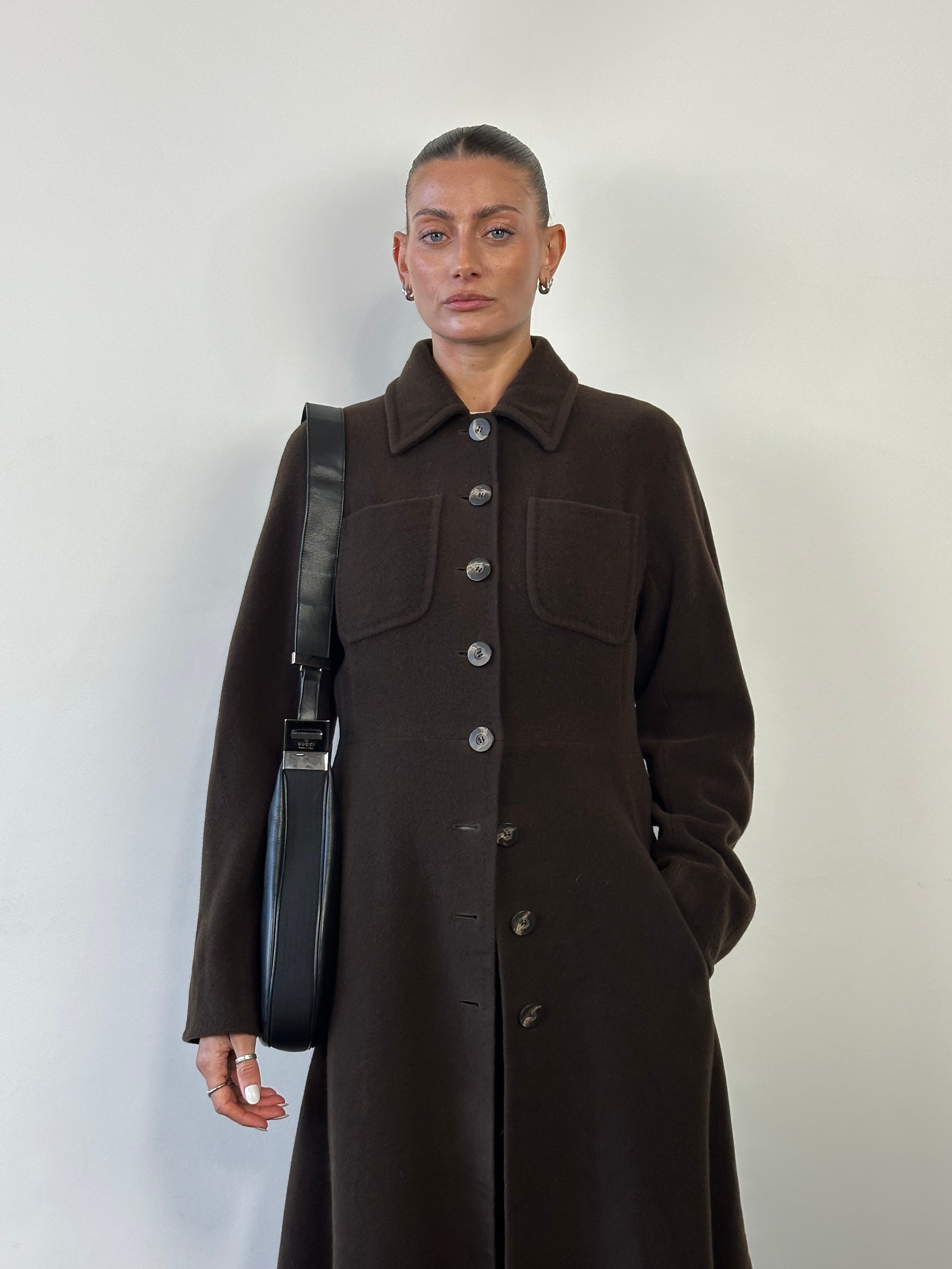 Max Mara pure wool A-line floor-length coat in size M, shown hanging on a hanger with a classic collar and tailored fit.