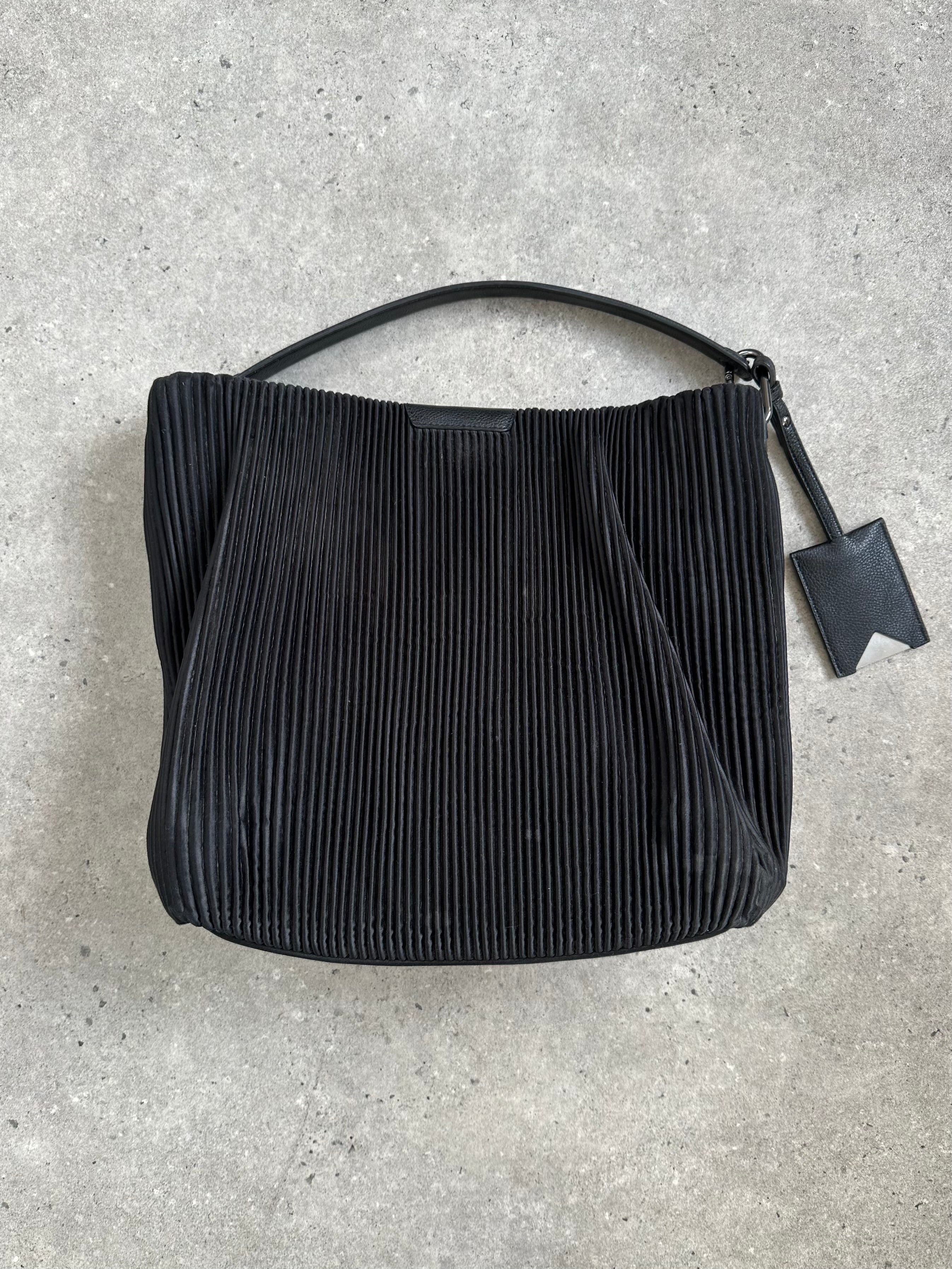Emporio Armani pleated shoulder bag with sleek design and elegant straps, showcasing a stylish accessory for everyday use.