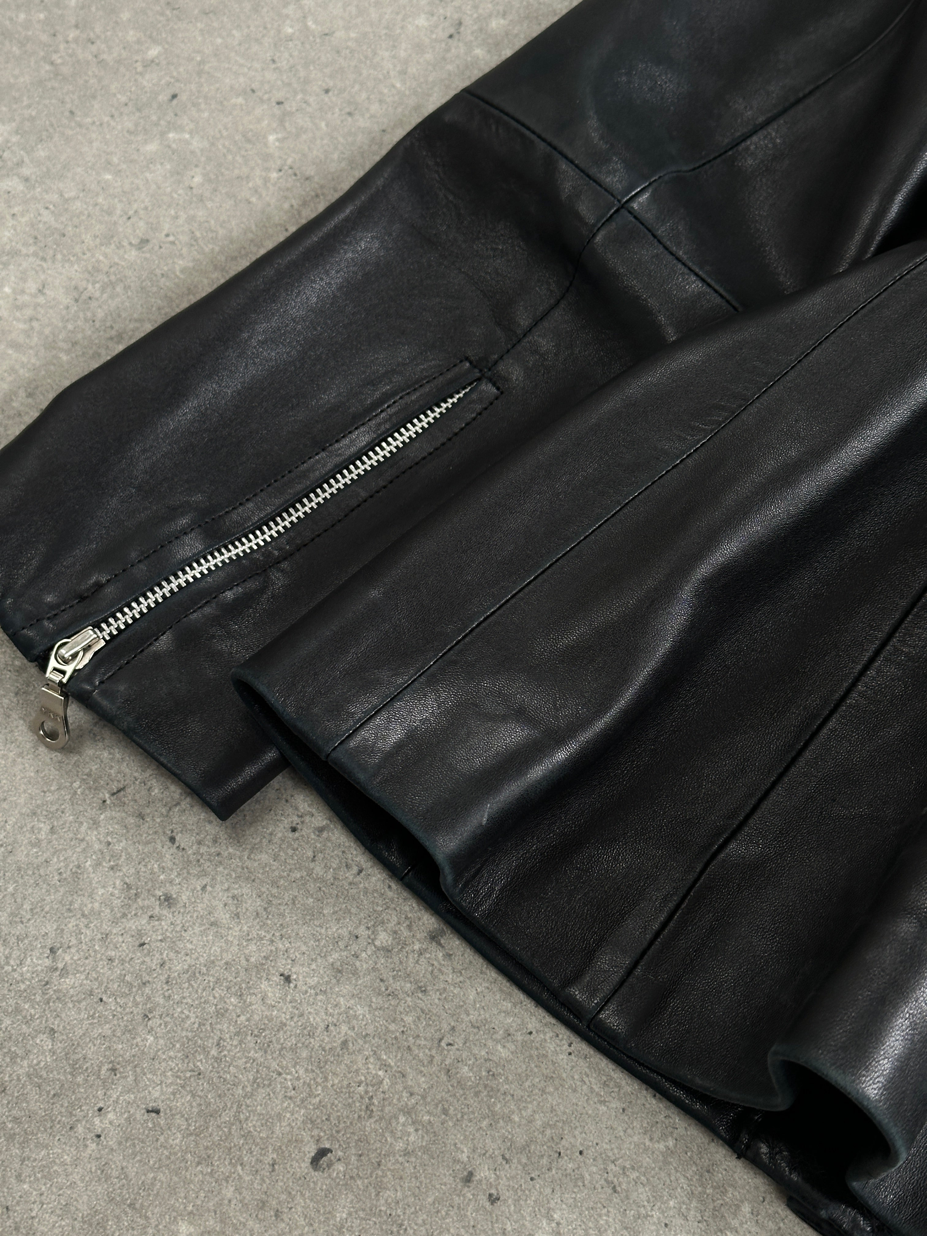 Vintage 1990s French leather jacket with high neck tie belt, featuring a classic design and high-quality leather finish.