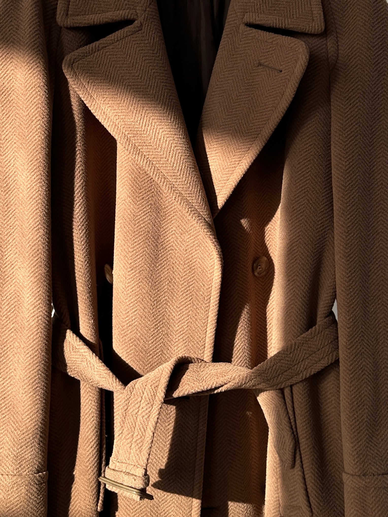 Christian Dior belted double-breasted wool coat in size L displayed on a hanger with classic tailored design and neutral color.